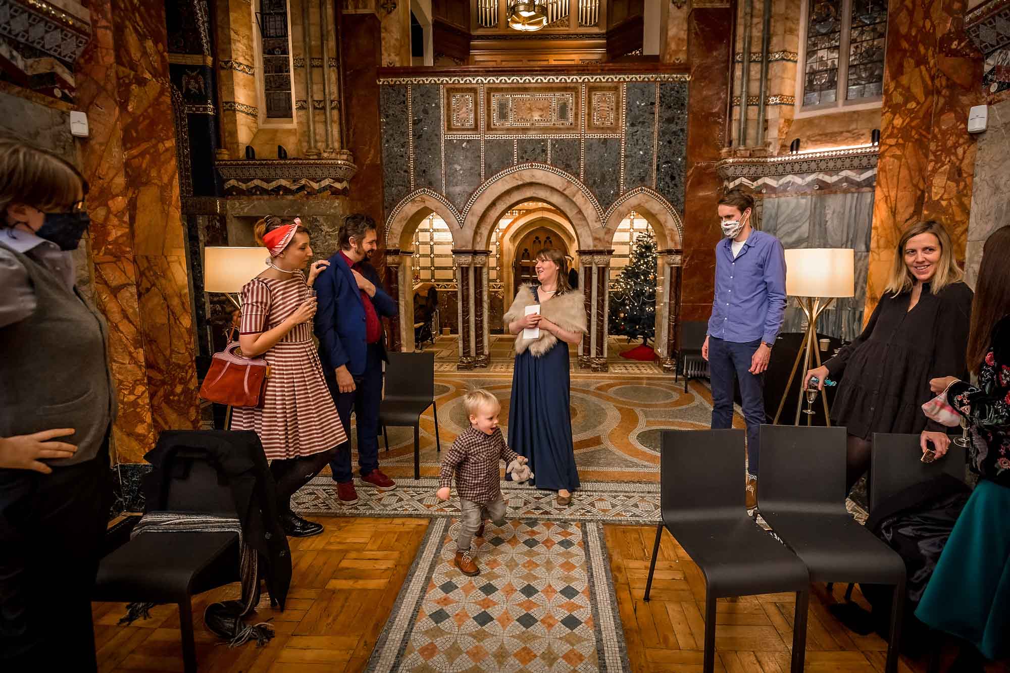 Guests socially distanced whilst little boy plays at a Fitzrovia Chapel wedding