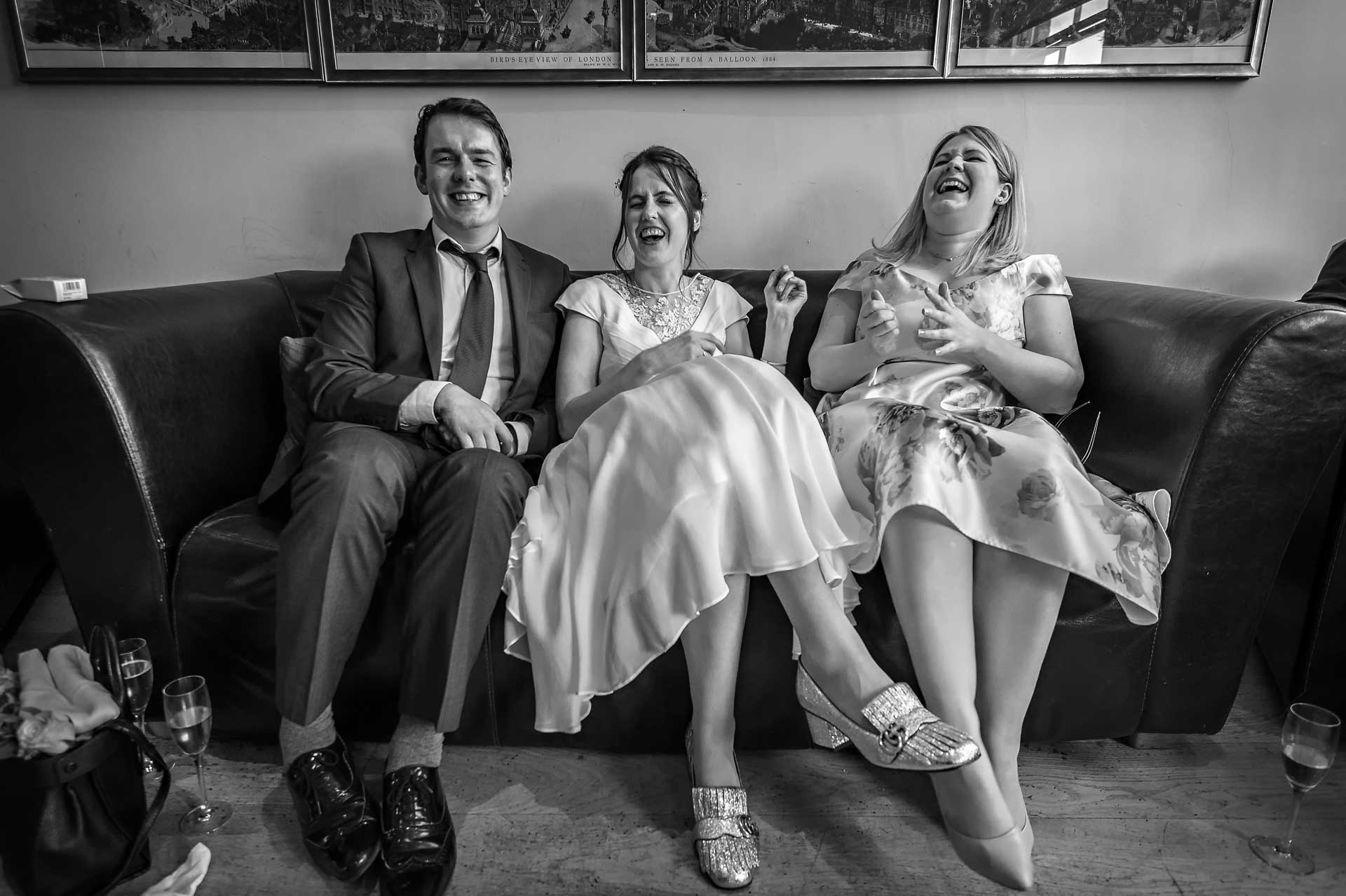 Bride laughing with guests at wedding reception