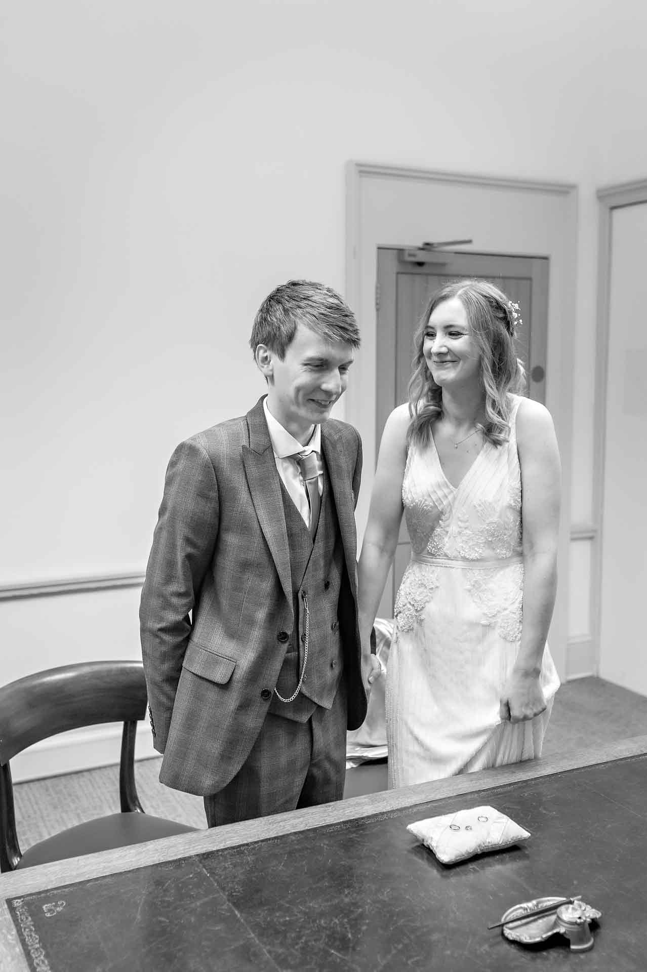 Bride smiling at groom at wedding in Statutory Room at Bristol Register Office