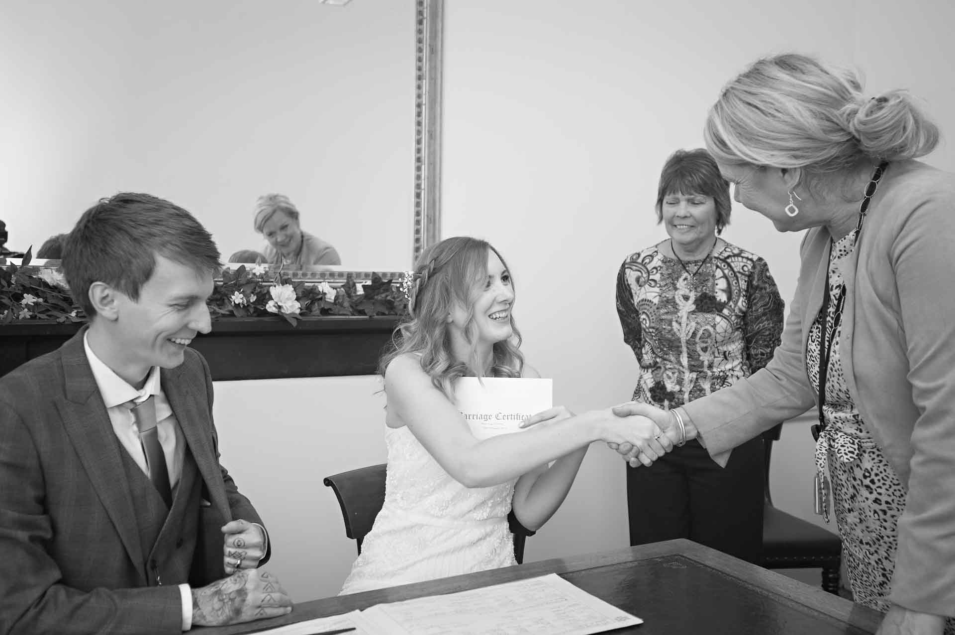 Bride shaking registrars hand after wedding ceremony