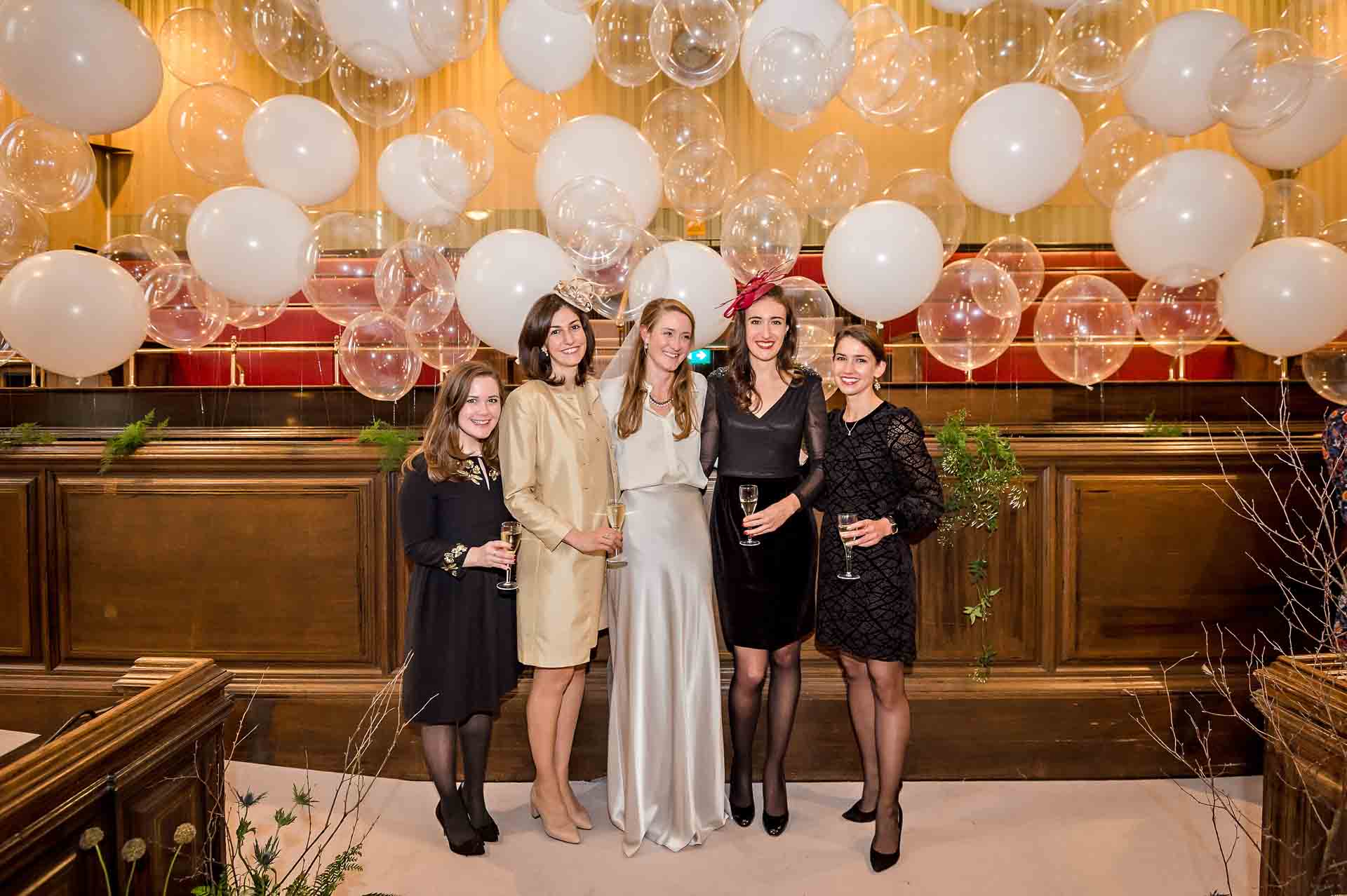 Bride with 3 friends pose for the camera in Bristol City Hall