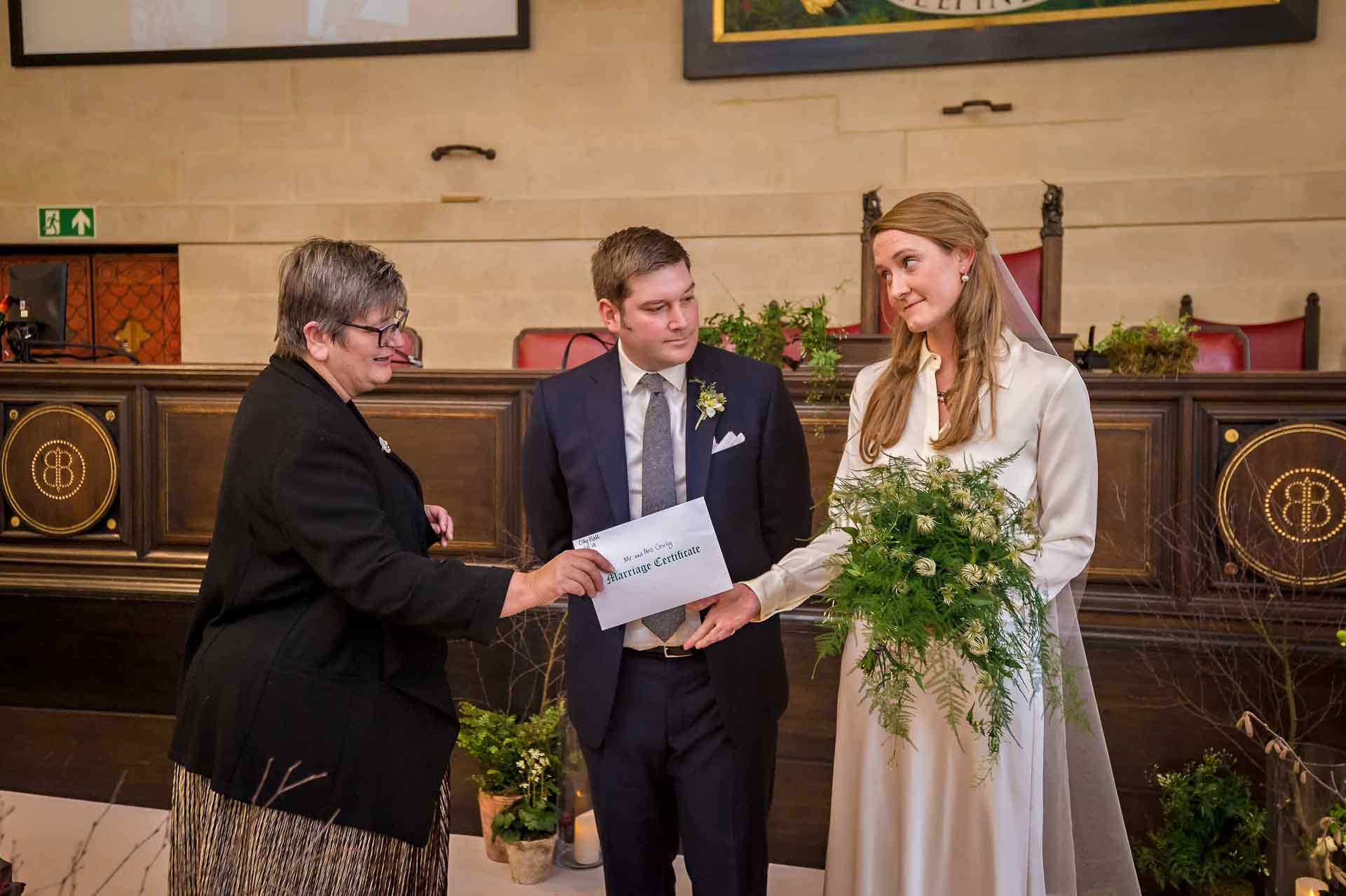 Bristol Registrar Hands Marriage Certificate to Bride at City Hall