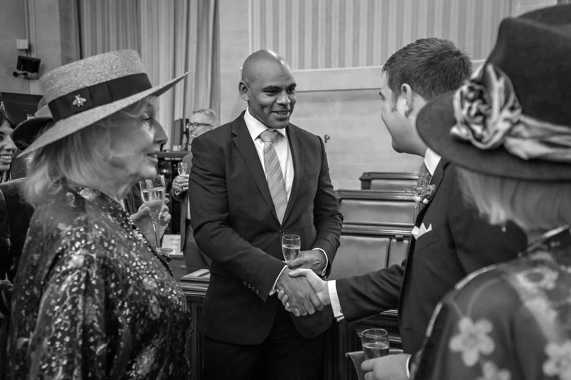 The Mayor of Bristol shakes the hand of the groom at a wedding in Bristol City Hall