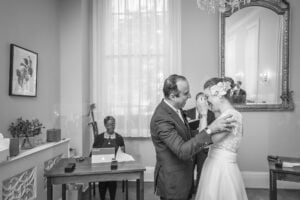 The couple laughing as they are just about to have their first kiss in the Brydon Room, Chelsea