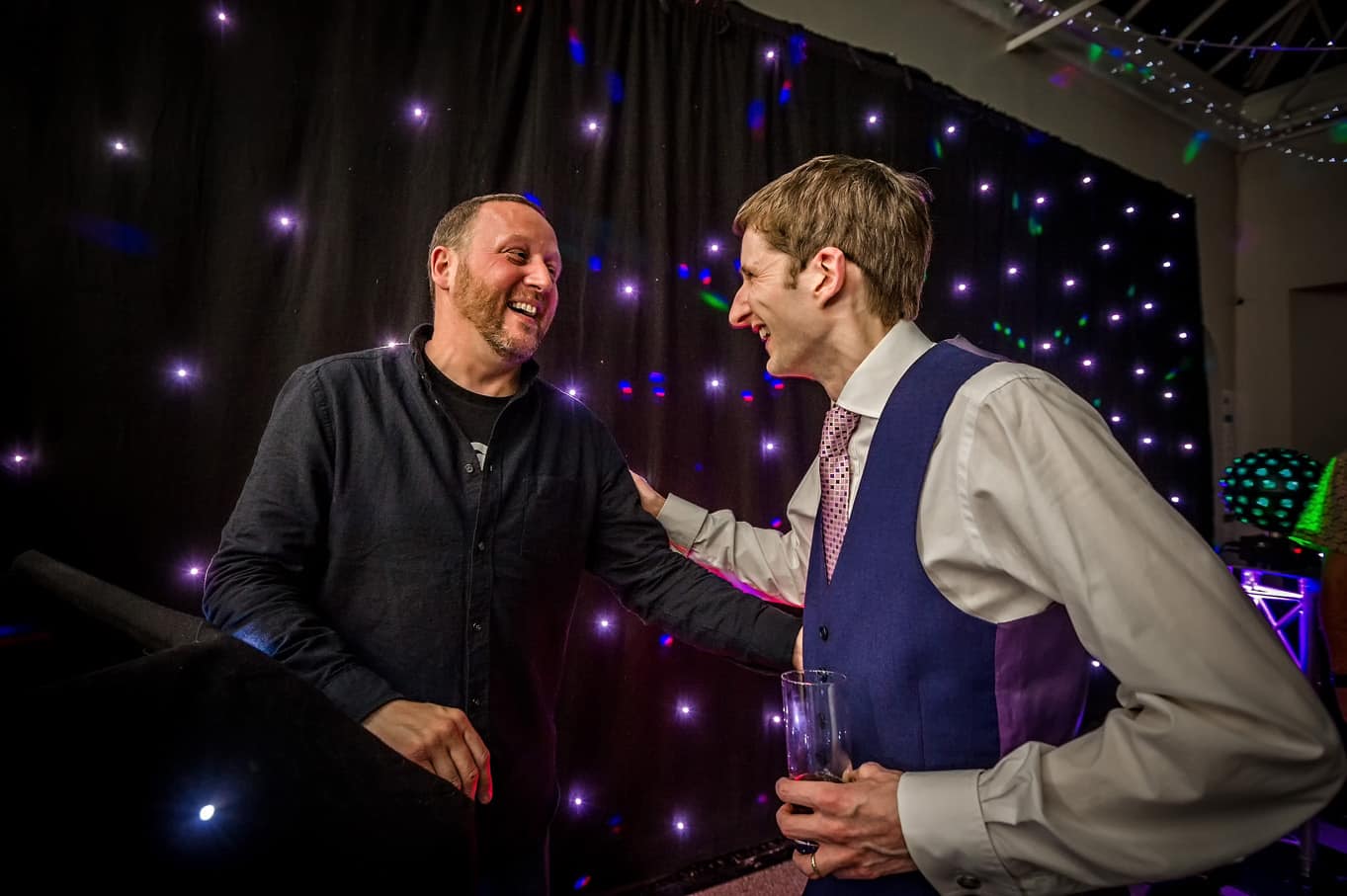 Groom meeting DJ at wedding at Hampton Court House