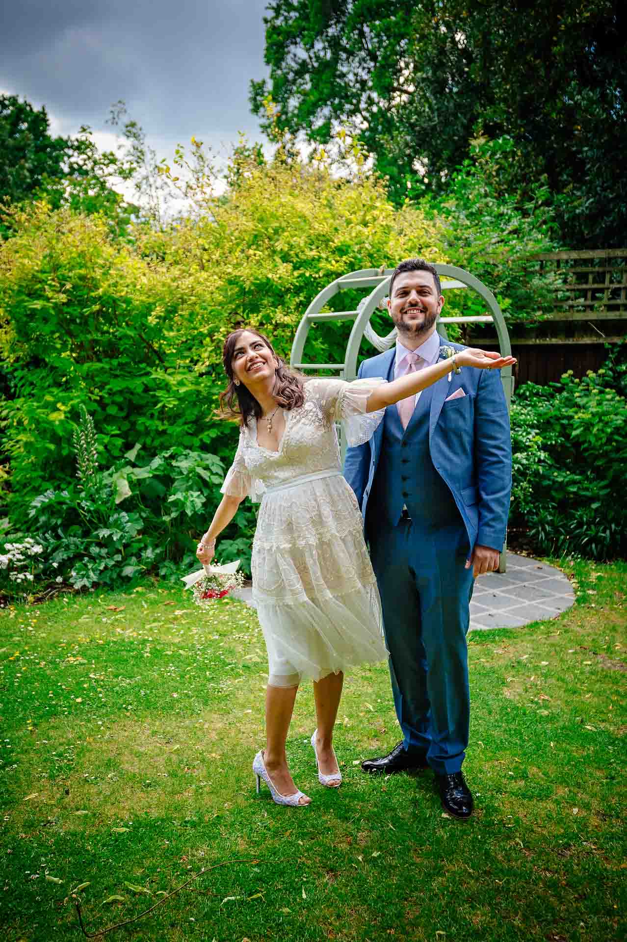 Bride messing about with groom in London garden