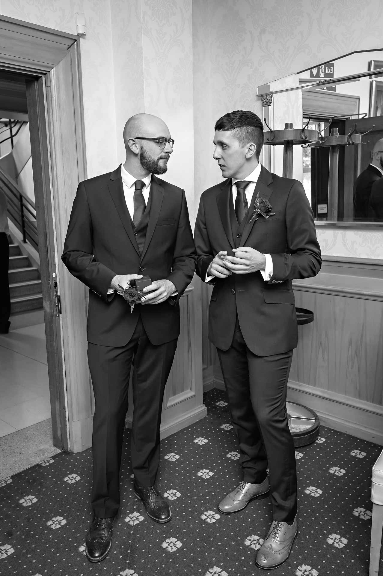 The groom and best man chat before marriage ceremony at Wandsworth Town Hall