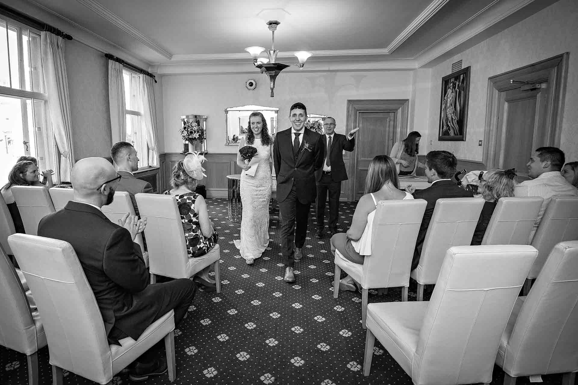 Bride and groom leaving the Alexandra Room at Wandsworth Town Hall
