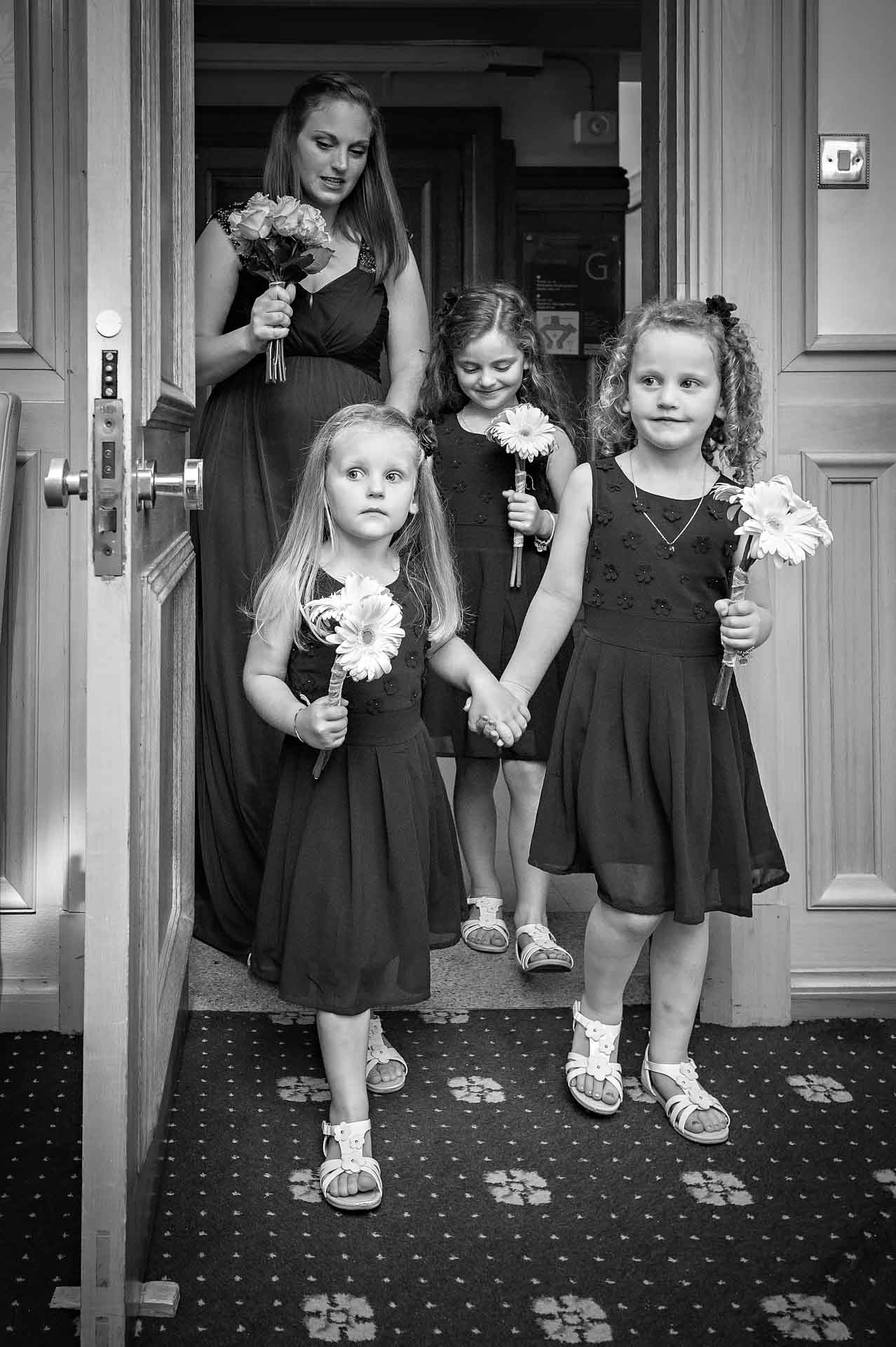 Young bridesmaids and grown up enter the Alexandra Room of Wandsworth Town Hall