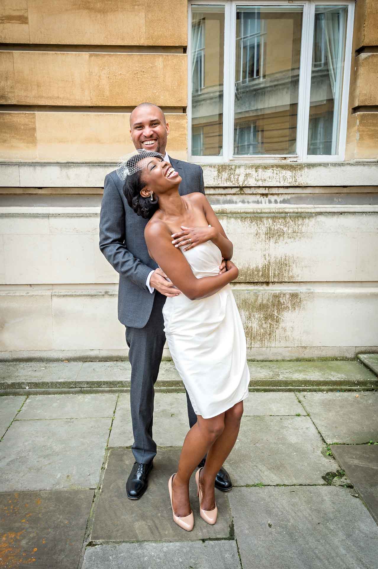 Bride and groom laughing outside Wandsworth Town Hall