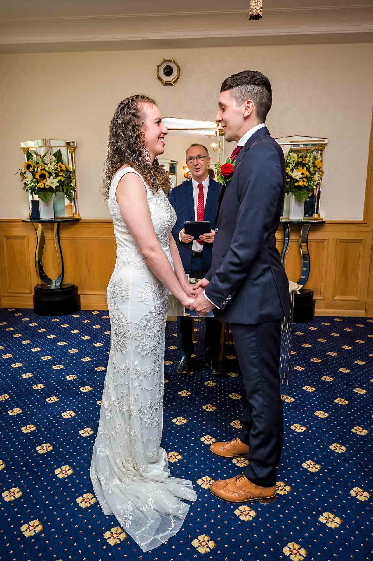 Bride and groom holding hands at Alexandra Room wedding in Wandsworth Town Hall
