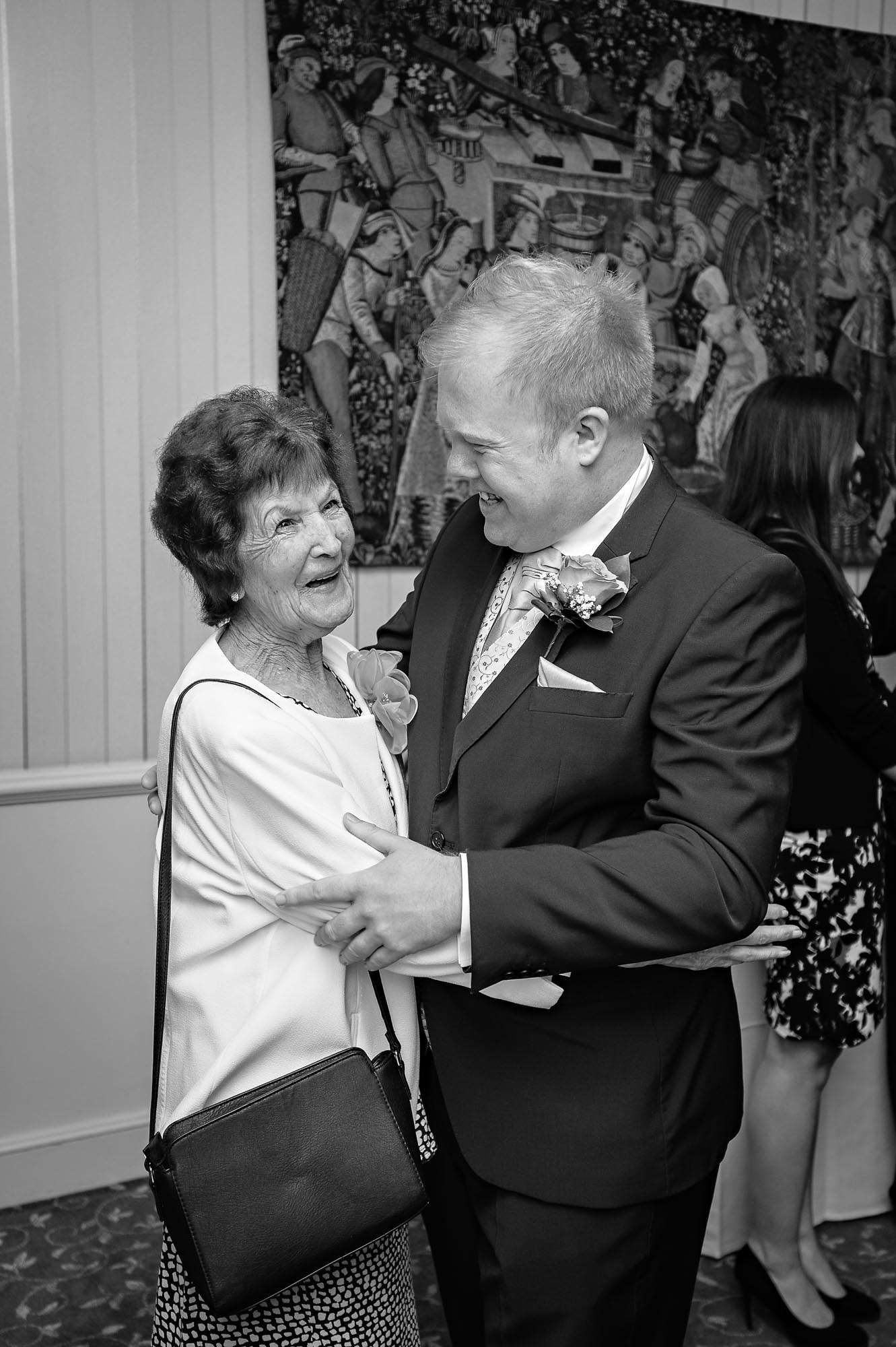 The groom holds his smiling grandma at a Cardiff wedding