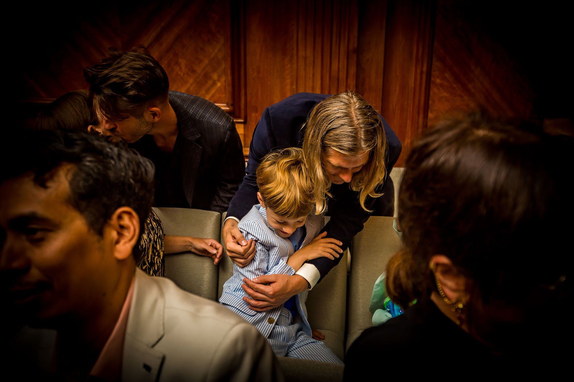 Male guest hugs boy at wedding in London