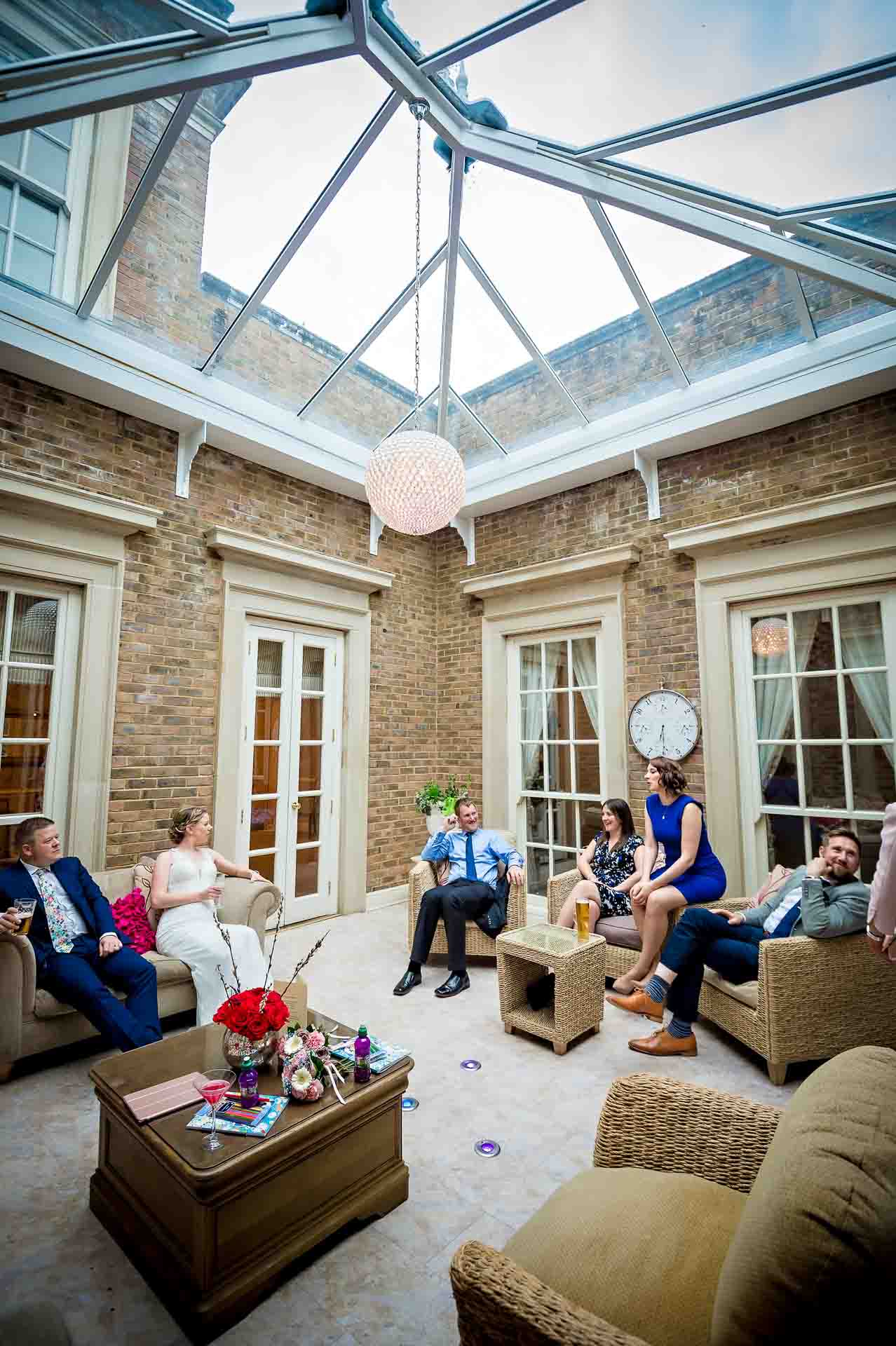 Guests talking in conservatory of DeCourceys Manor