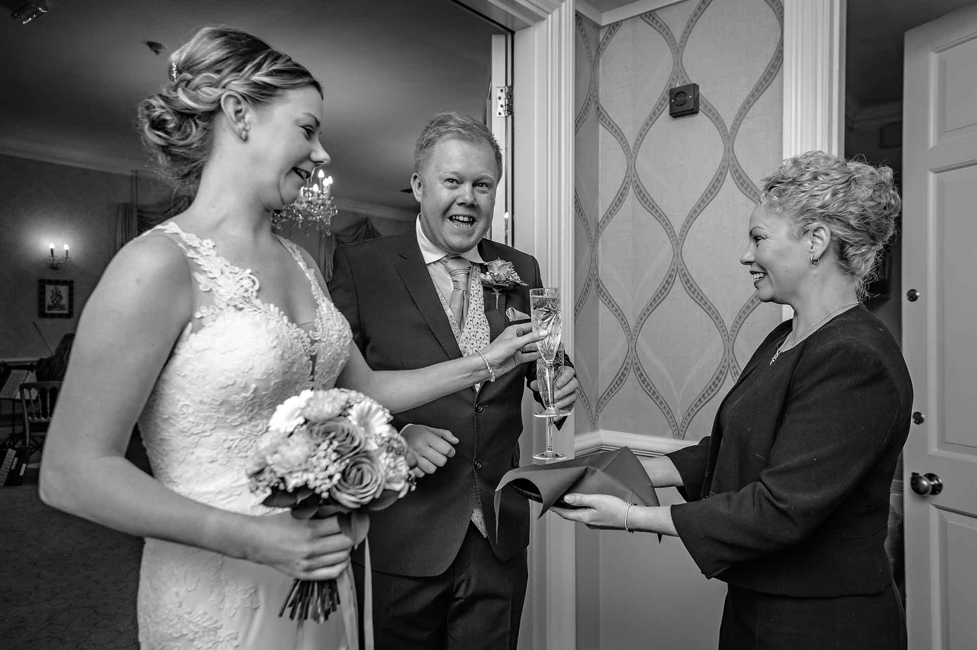 Couple Taking Champagne of Tray at DeCourceys Manor Wedding