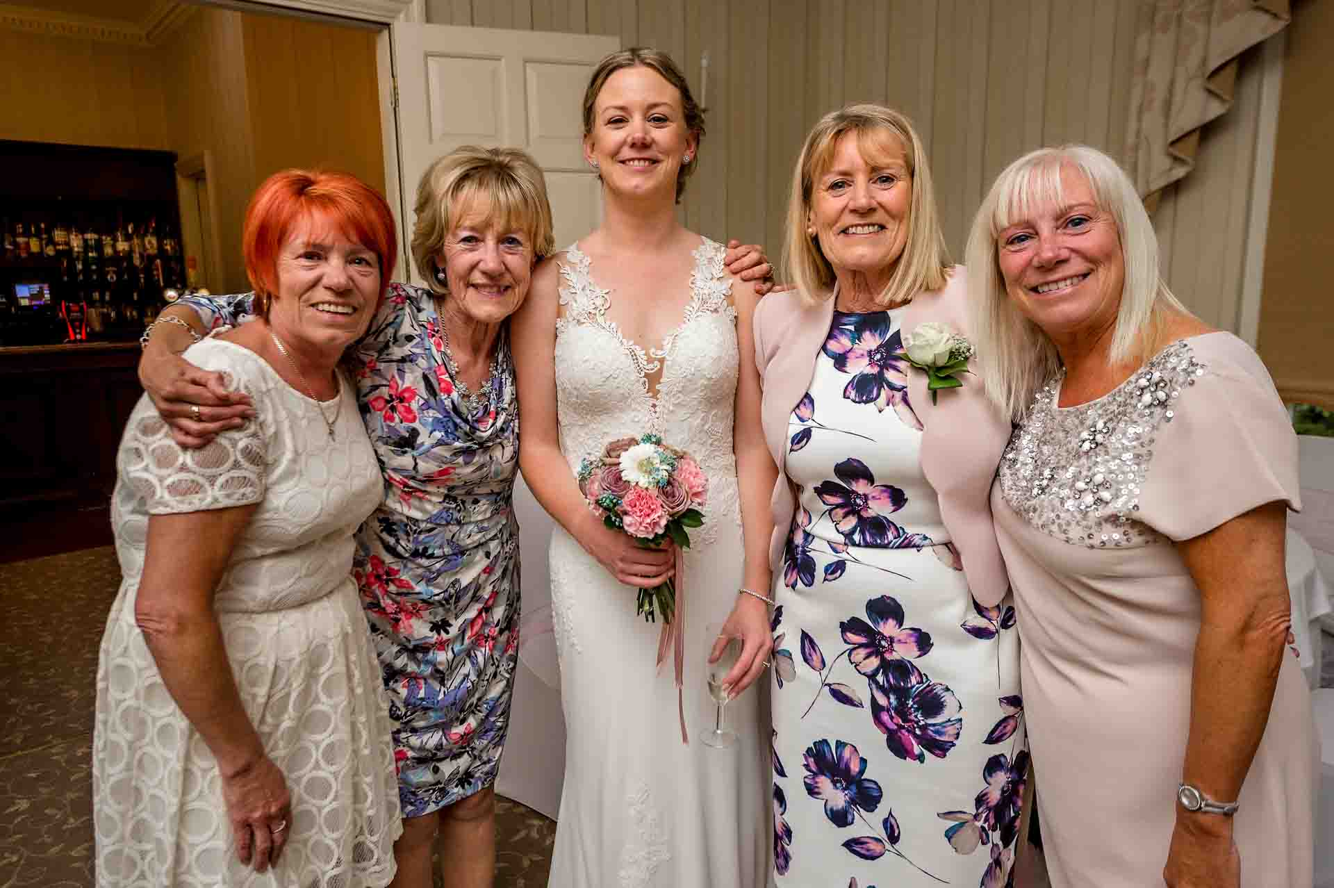 Bride posing with older female relatives at wedding