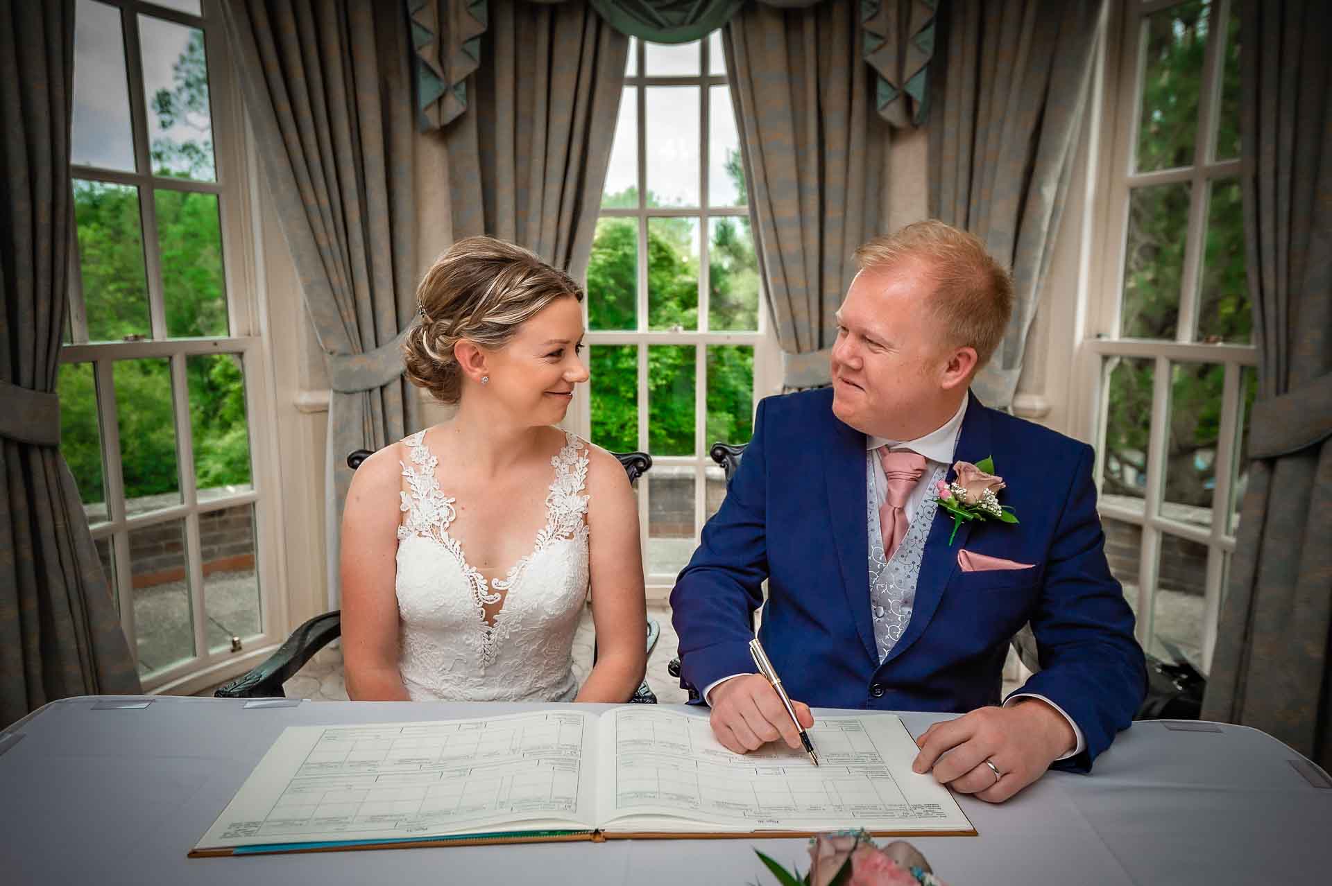 Groom Signing Register with Large Bay Windows