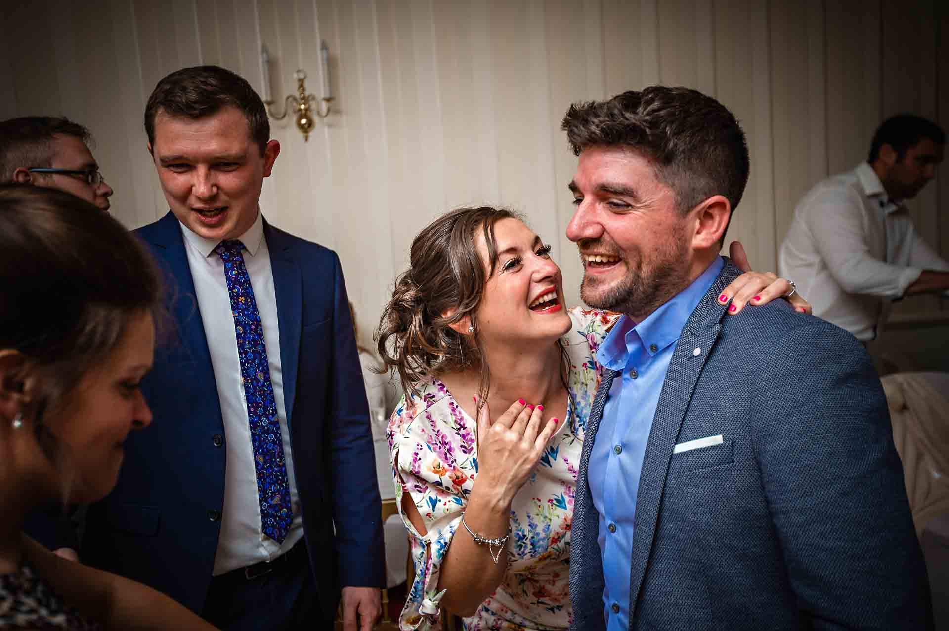 Guests laughing at wedding near Cardiff
