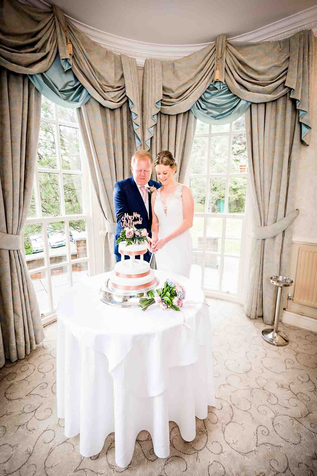 Bride and Groom cut the cake at DeCourceys Manor