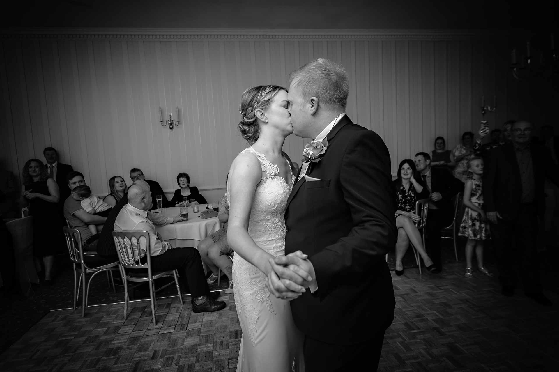 Bride and groom kissing during first dance