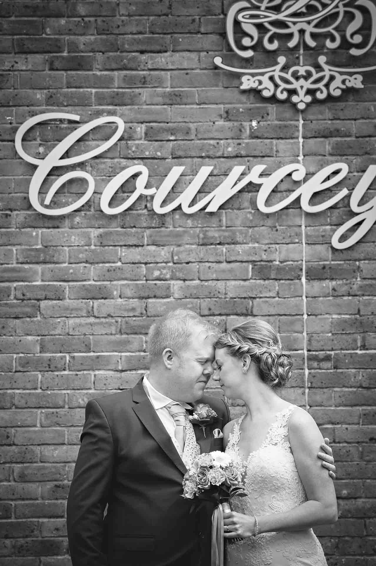 Bride and groom holding each other in romantic embrace