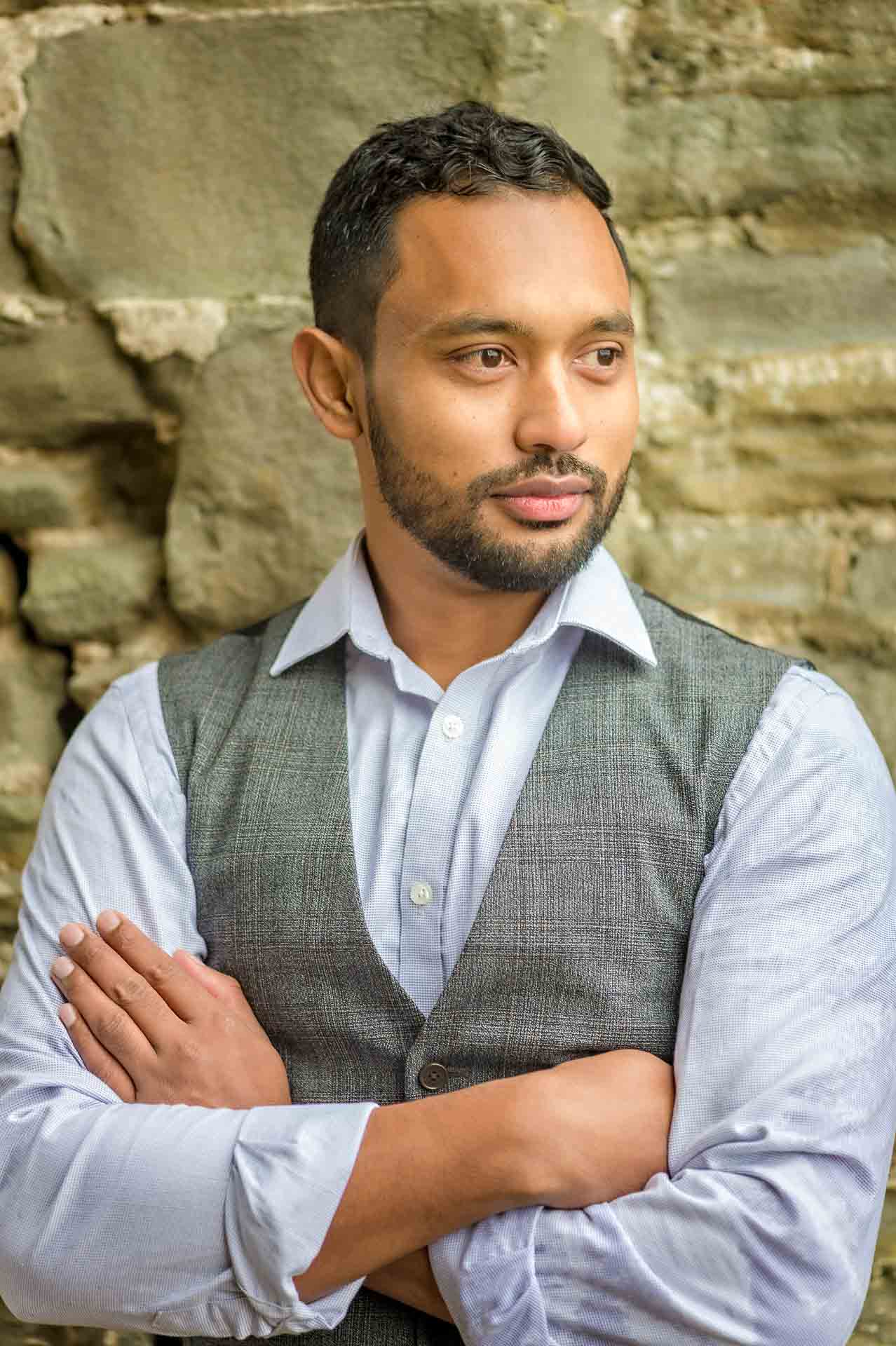 Head shot of male with arms folded looking away from camera for online dating profile