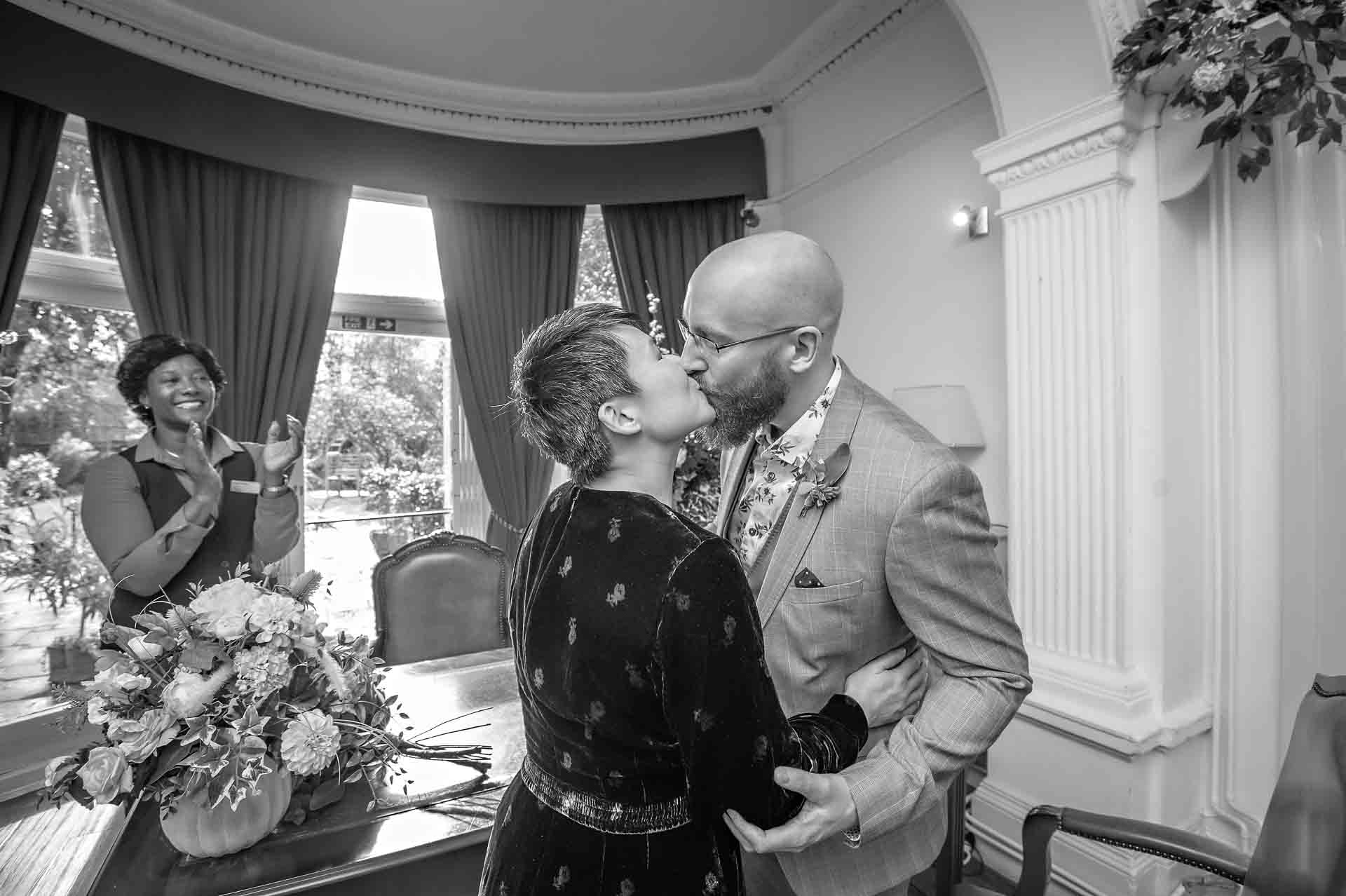 A newly-wedded couple share their first kiss at Southwark Register Office