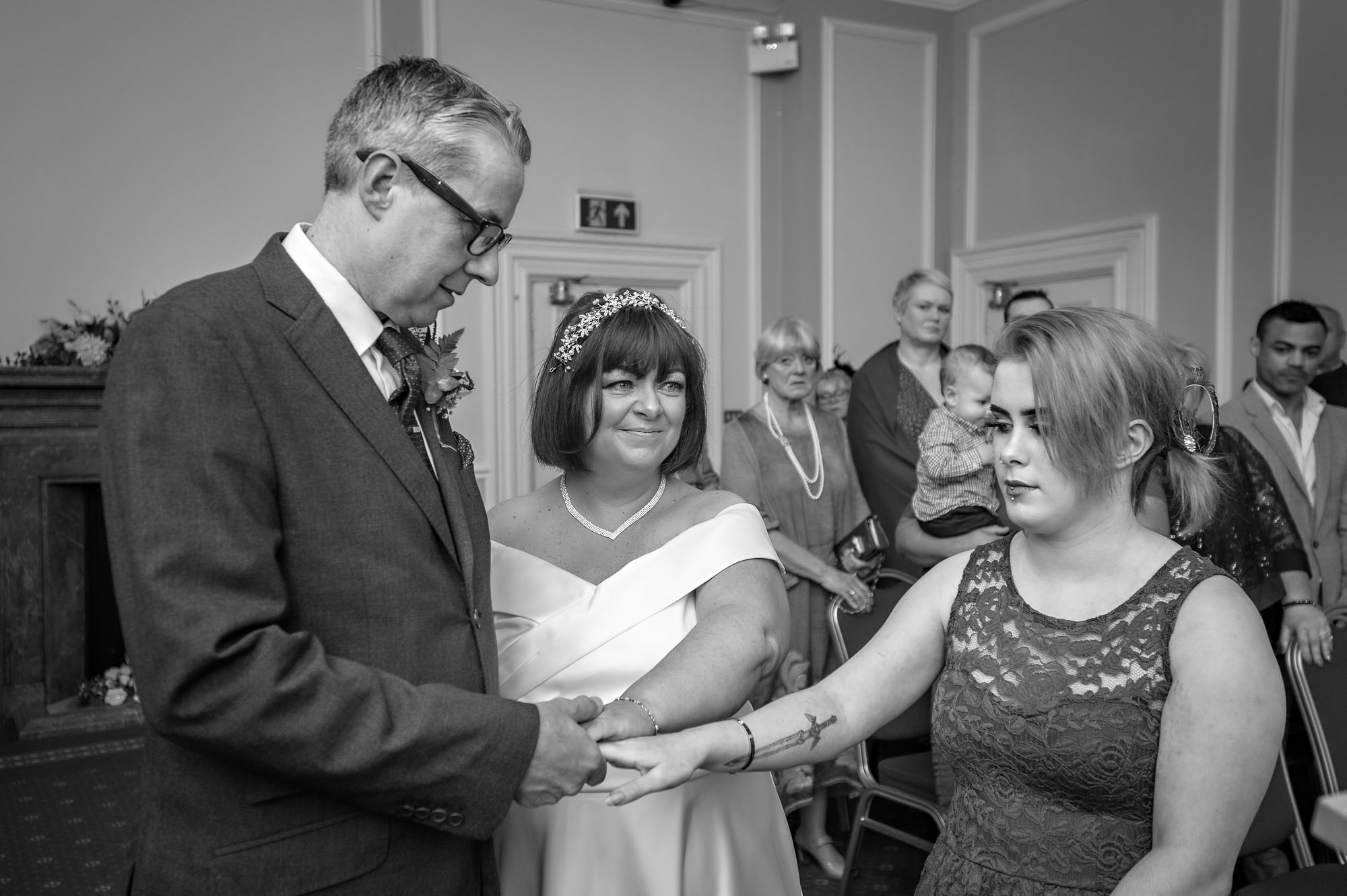 Female family member gives away the bride at a wedding in Cardiff City Hall's St David's Room