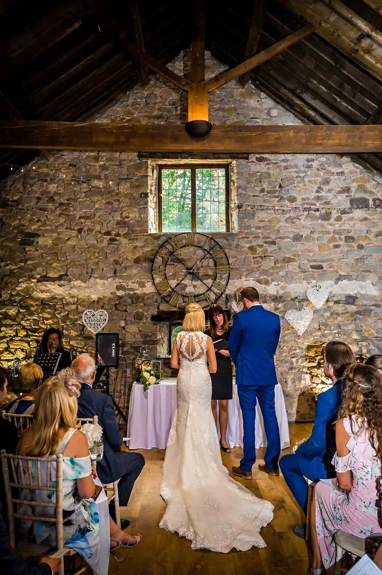 The Bride and Groom with the register in the Old Barn