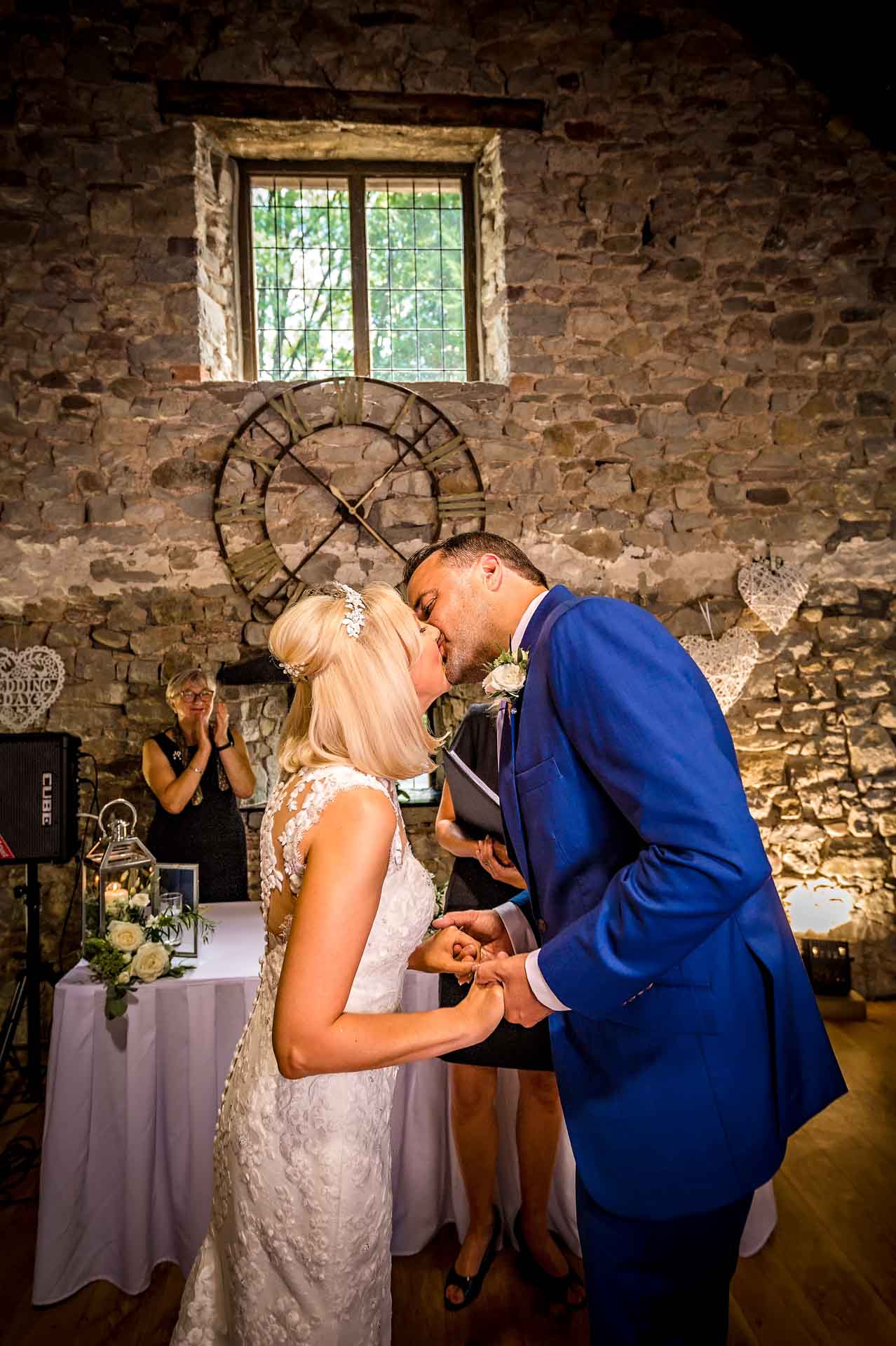 Newly-Weds Kissing after Ceremony in Barn