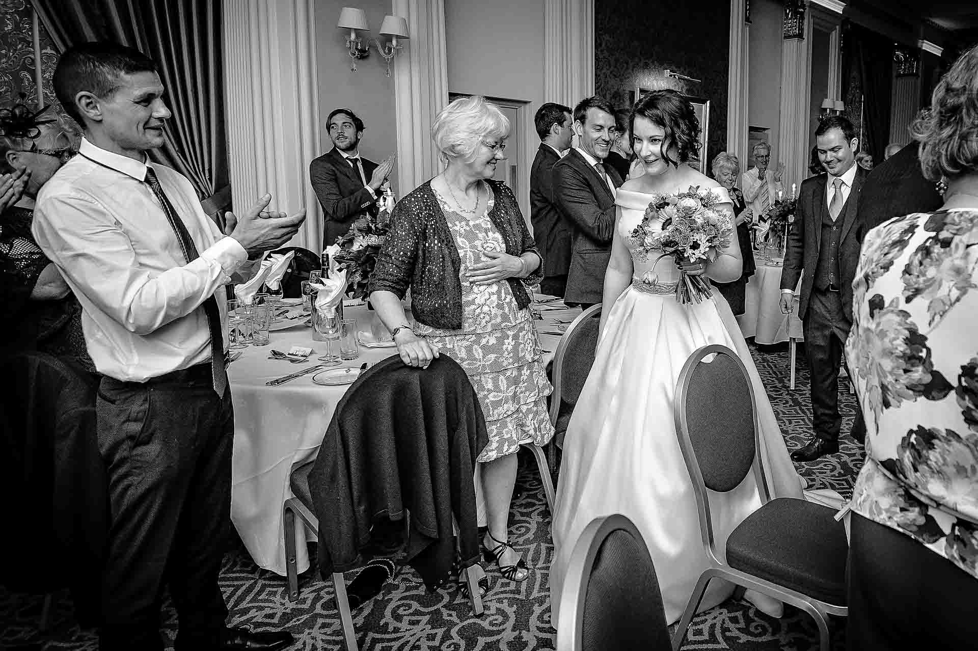 The bride and groom being welcomed by their wedding guests at RAF Club, London