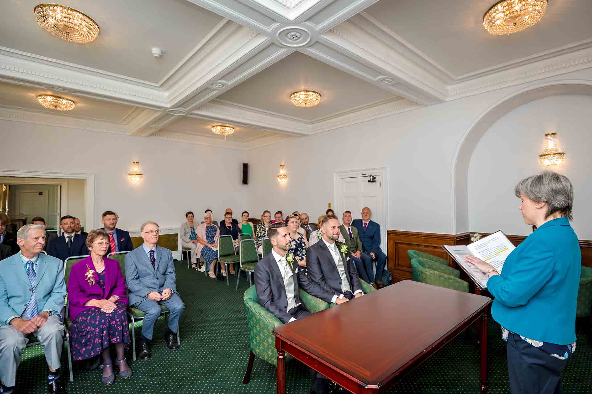 The registrar reads with guests watching at a wedding at Bromley Register Office