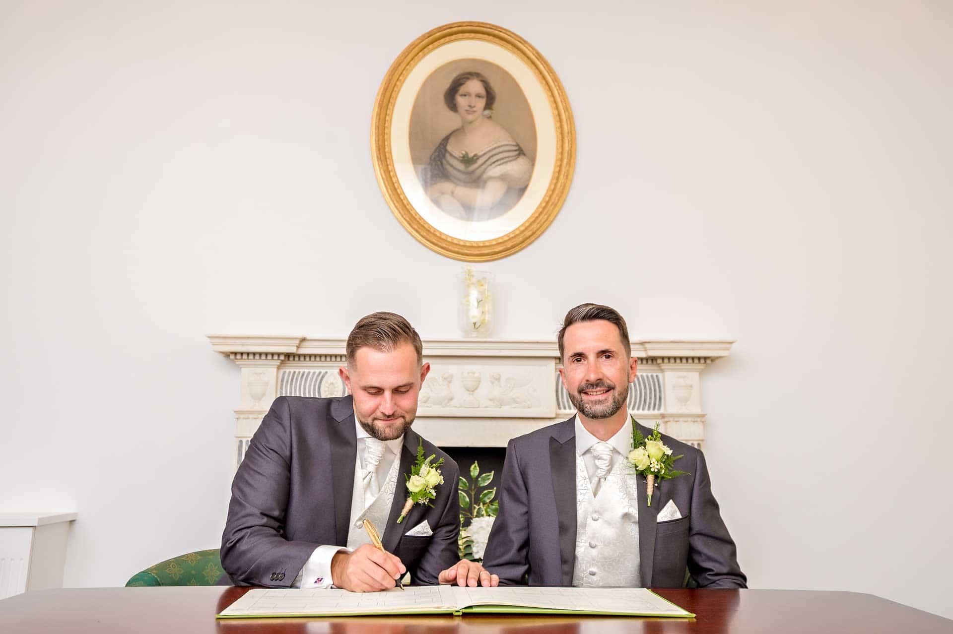 Groom poses for dummy wedding register signing at LGBT marriage