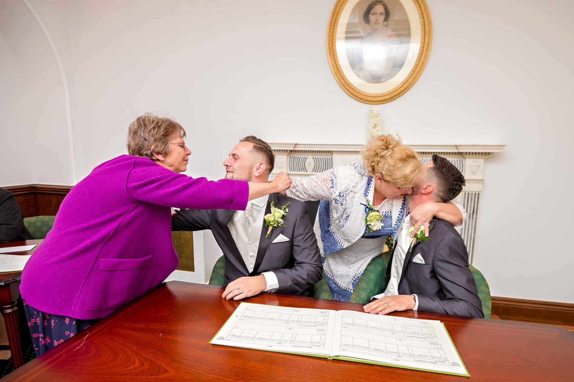 Mothers hug grooms at gay wedding in Kent