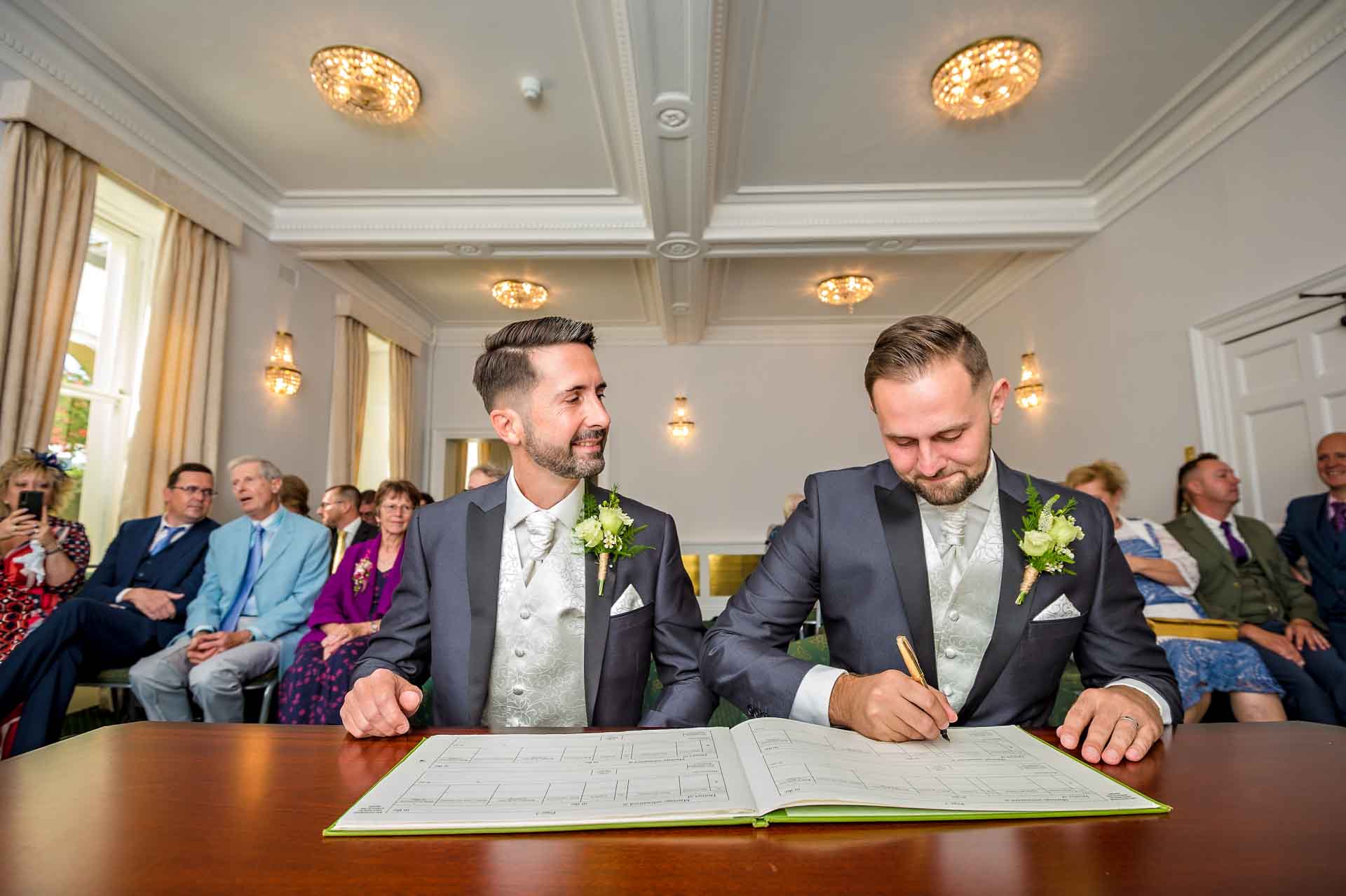 Posed signing of dummy register at gay wedding in Bromley Civic Centre