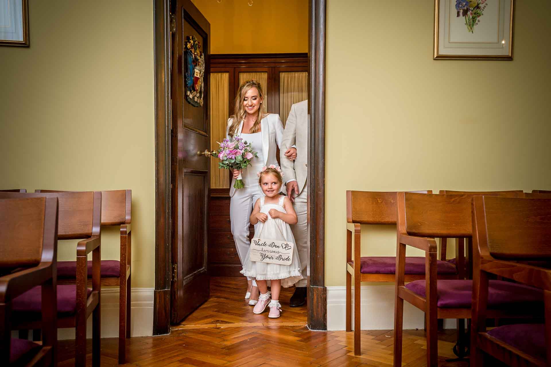 The bride enters the Brydon Room in Chelsea with her daughter for her wedding