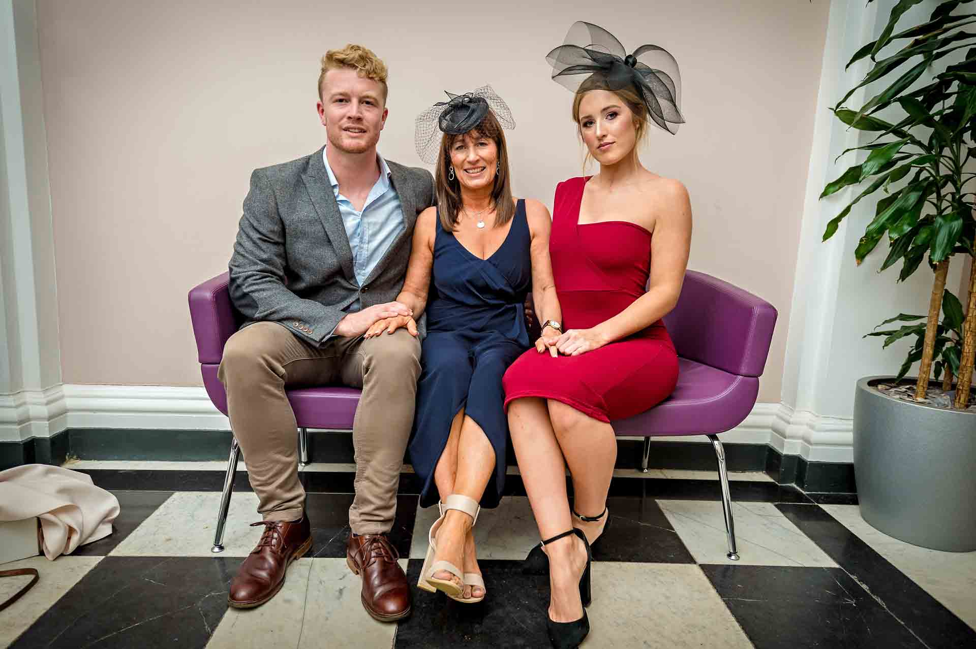 Three wedding guests waiting in waiting area at Chelsea Old Town Hall