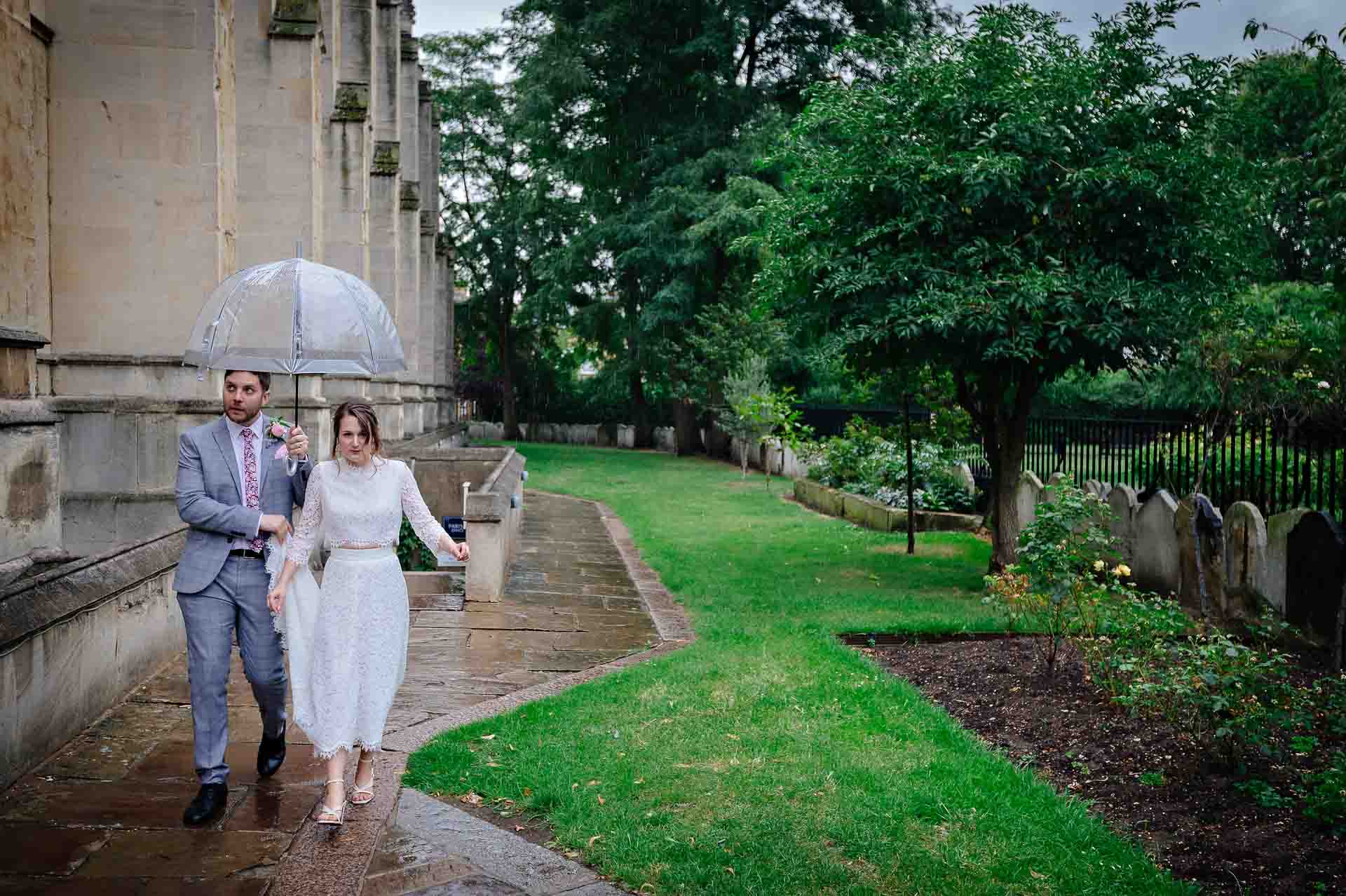 Wedding couple walking by the side of St Luke's Church in London