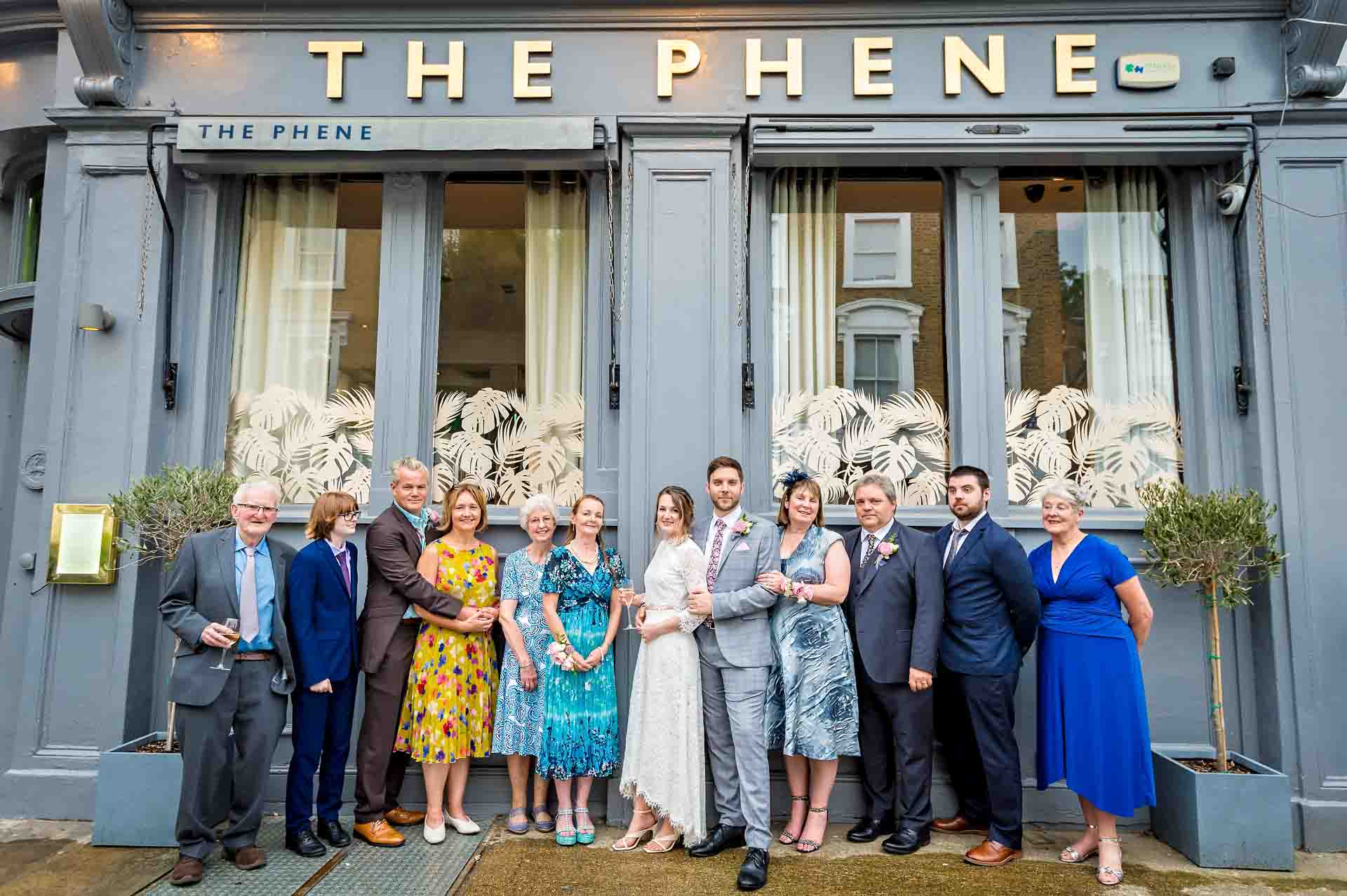 Group wedding portrait outside the Phene pub in Chelsea