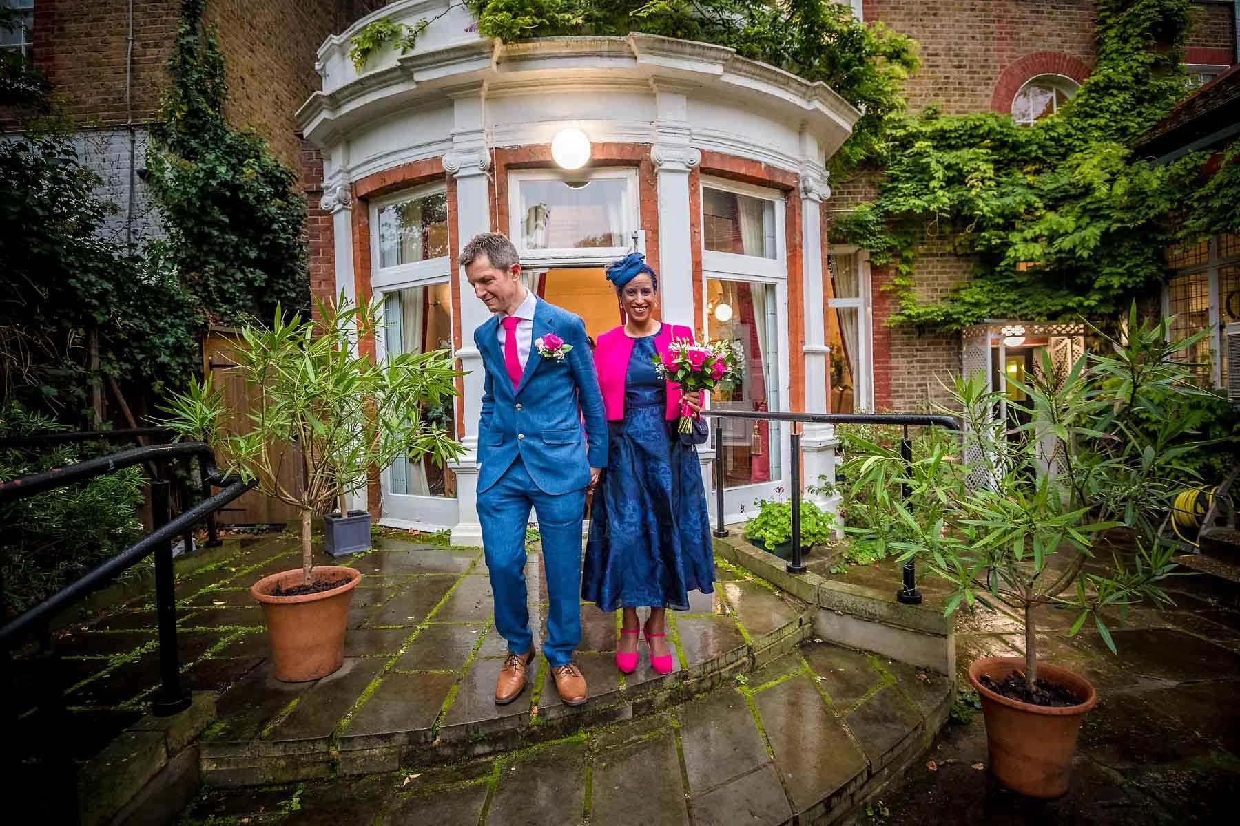Colourful newlyweds leaving the garden room at Southwark Register Office