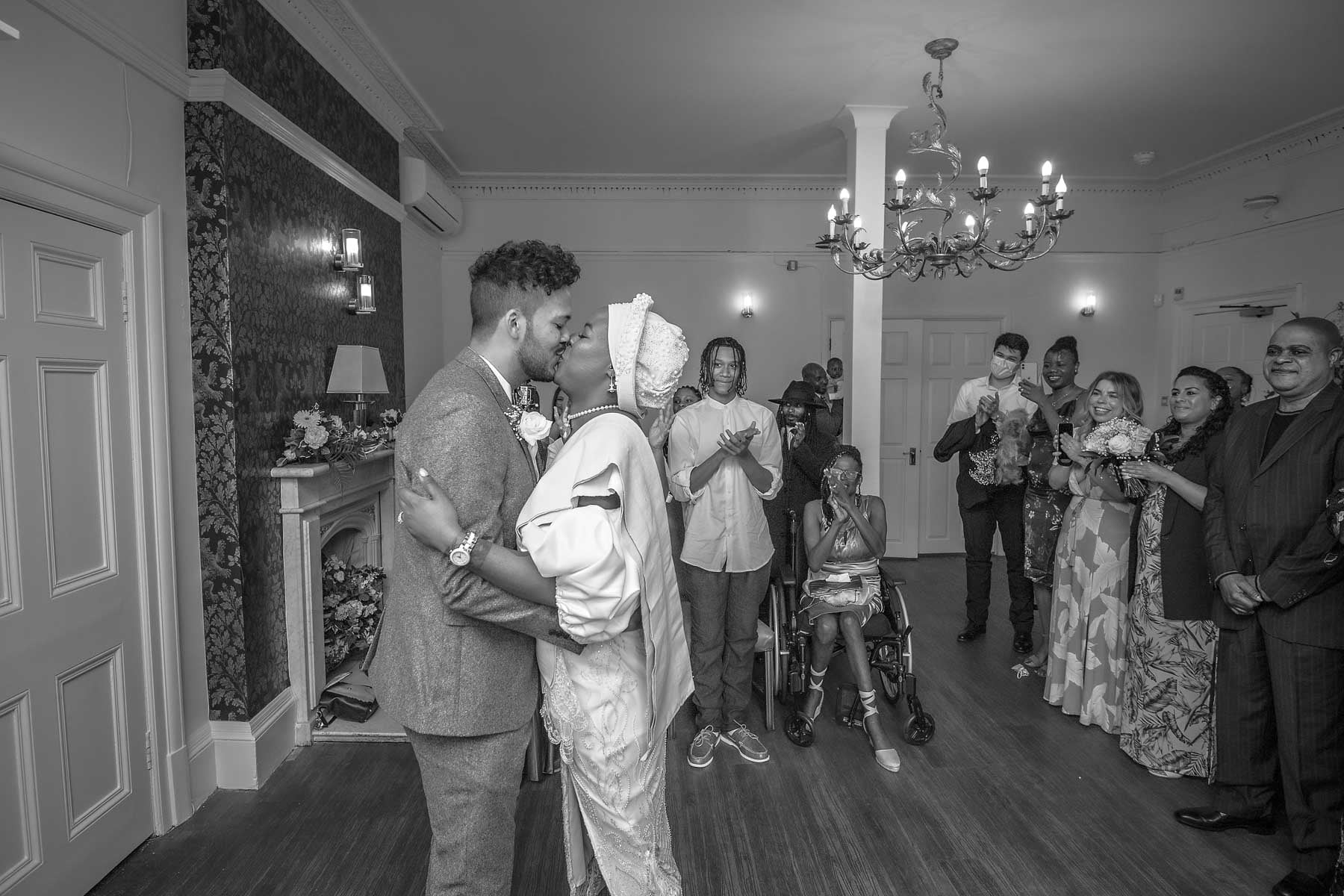 The newlyweds kiss at Southwark Register Office - black and white photo