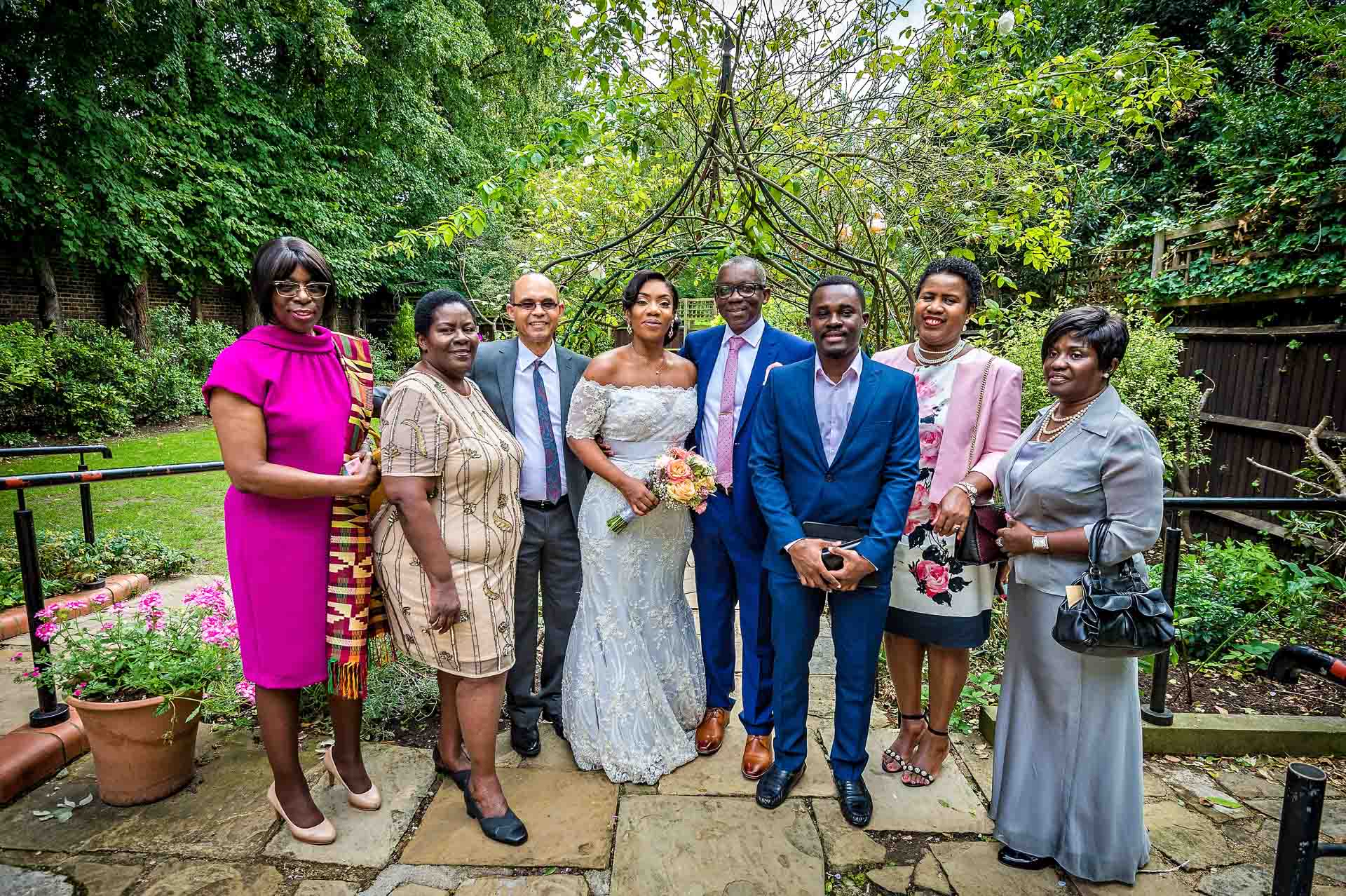 Group wedding portrait in garden at Southwark Register Office