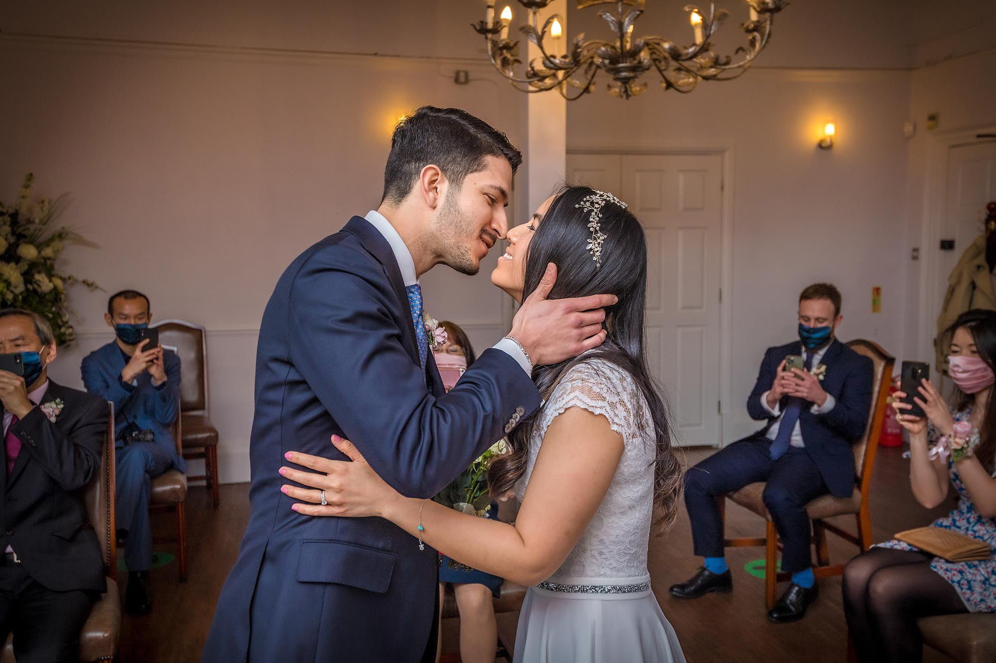 Southwark Register Office The couple have a tender first kiss at a London wedding