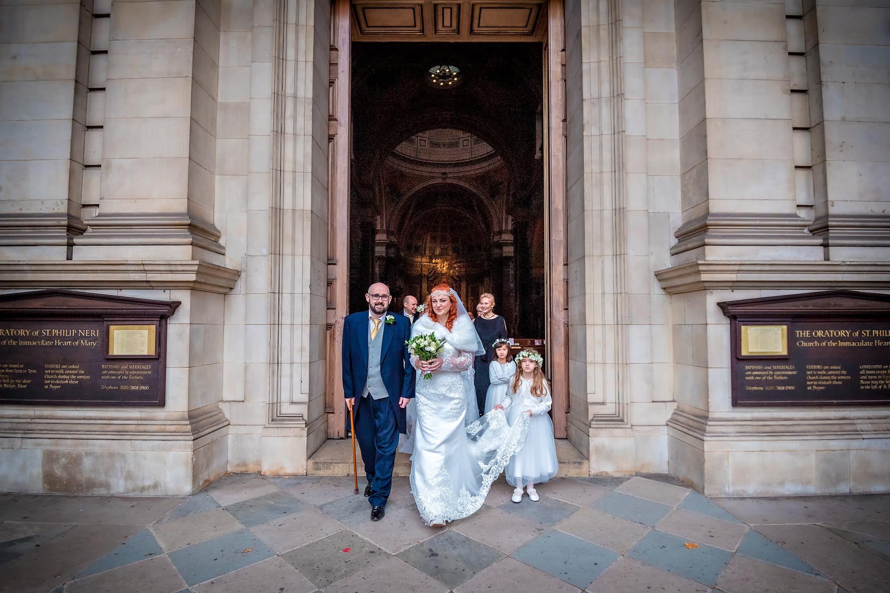 Bride and Groom leaving their Catholic wedding at Brompton Oratory, London