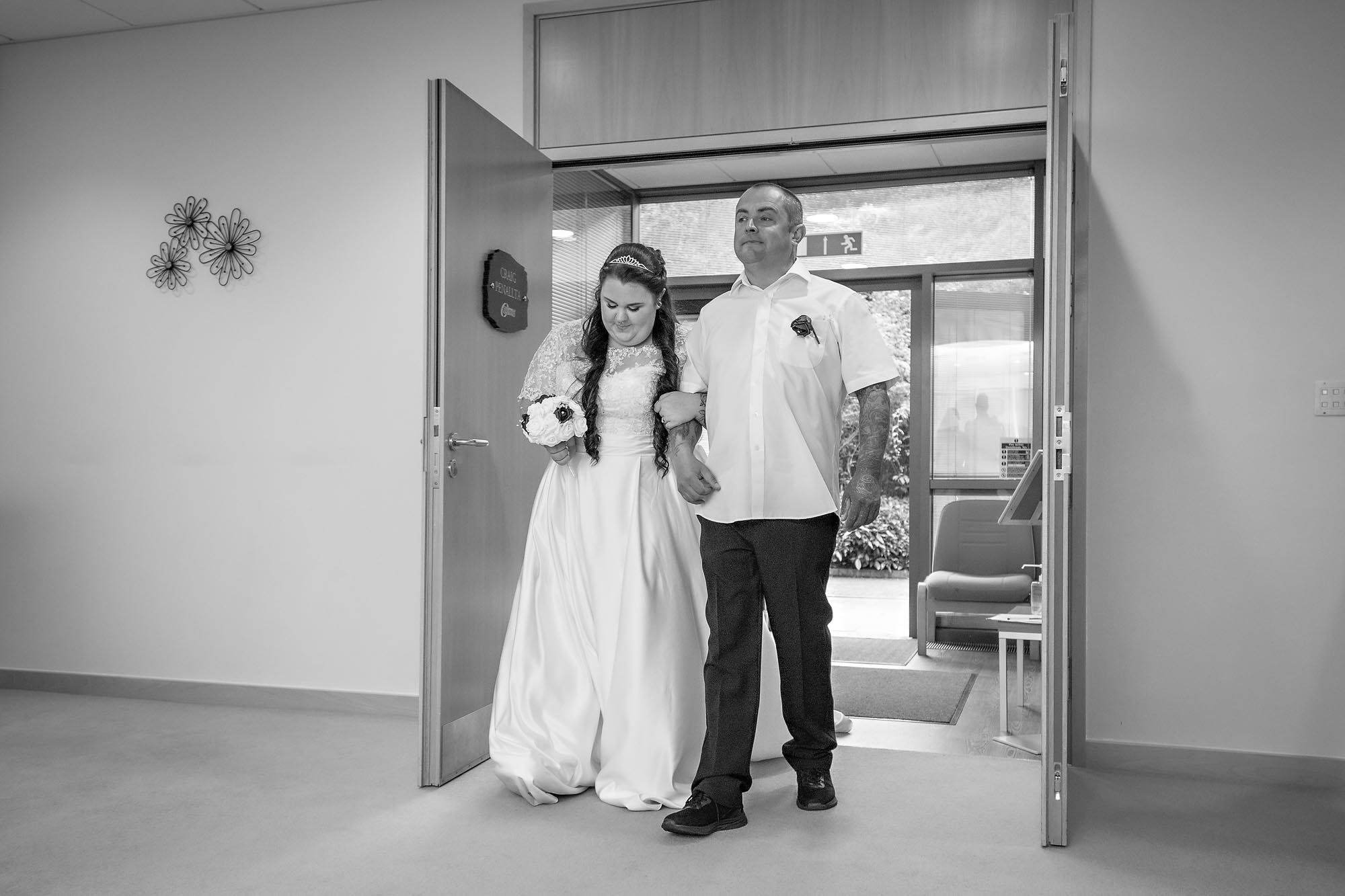 Bride and uncle enter the Ceremony Room at her wedding in Penallta House