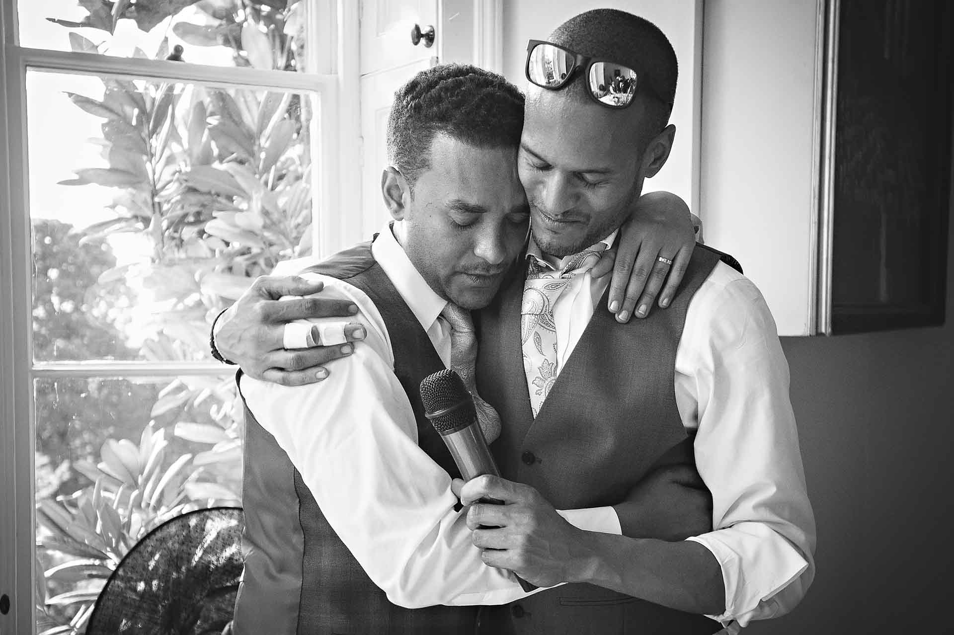 Best Man and Groom Hugging at London Wedding