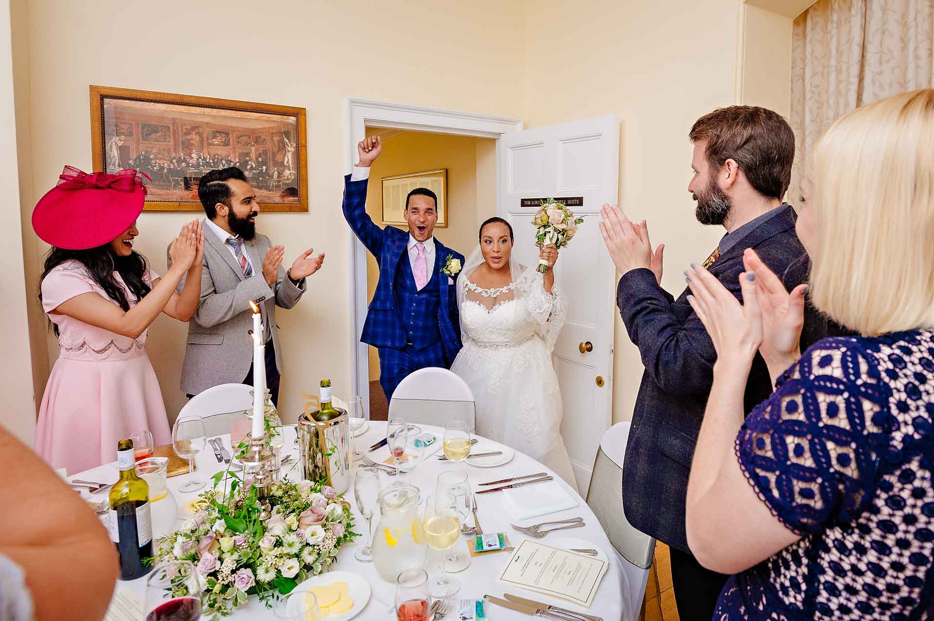 Newly-weds Entering Dining Room for Wedding Breakfast - Groom with Fist in Air Cheering
