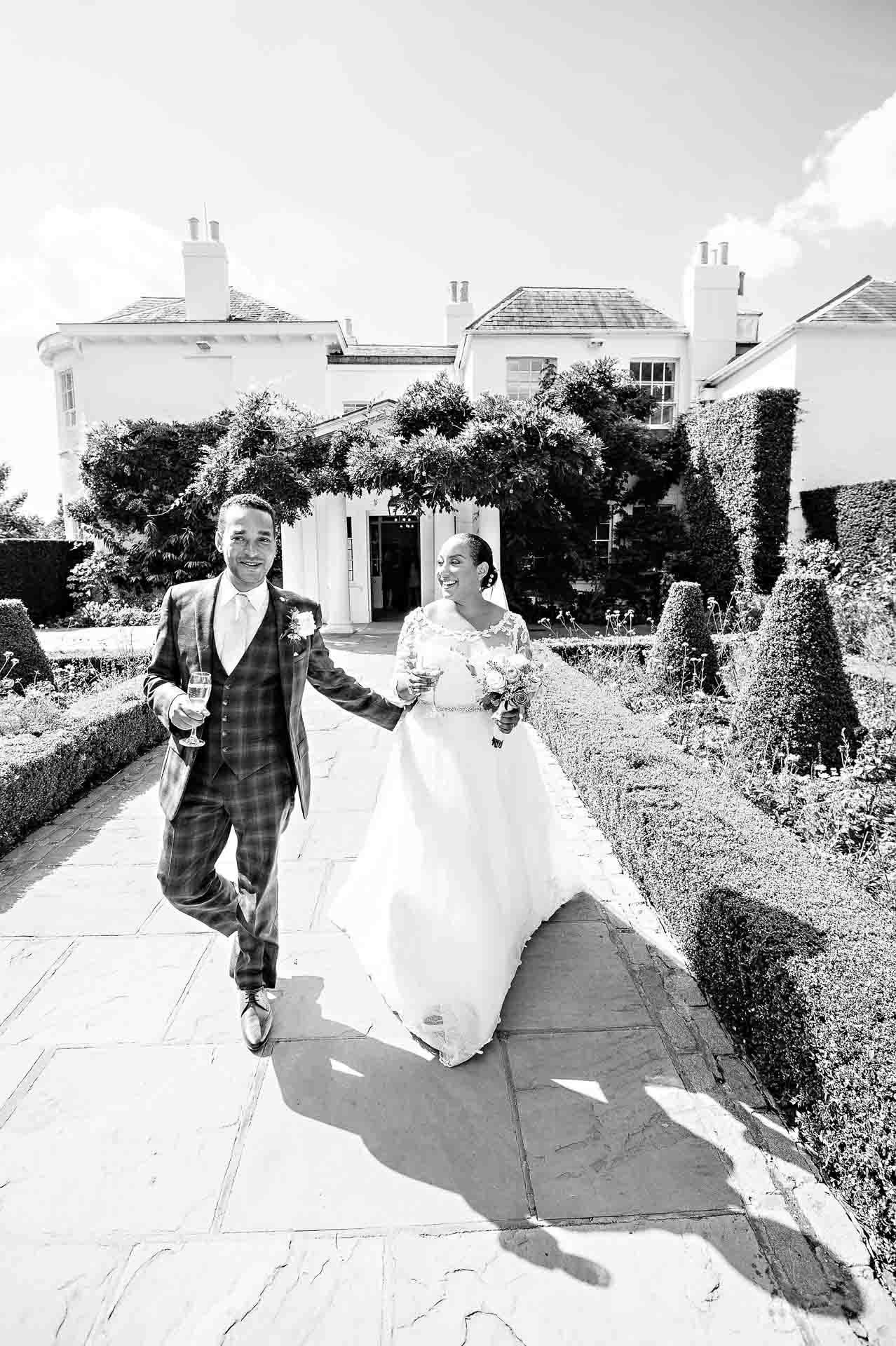 Pembroke Lodge Wedding Couple Walking Down Path Outside in Black and White