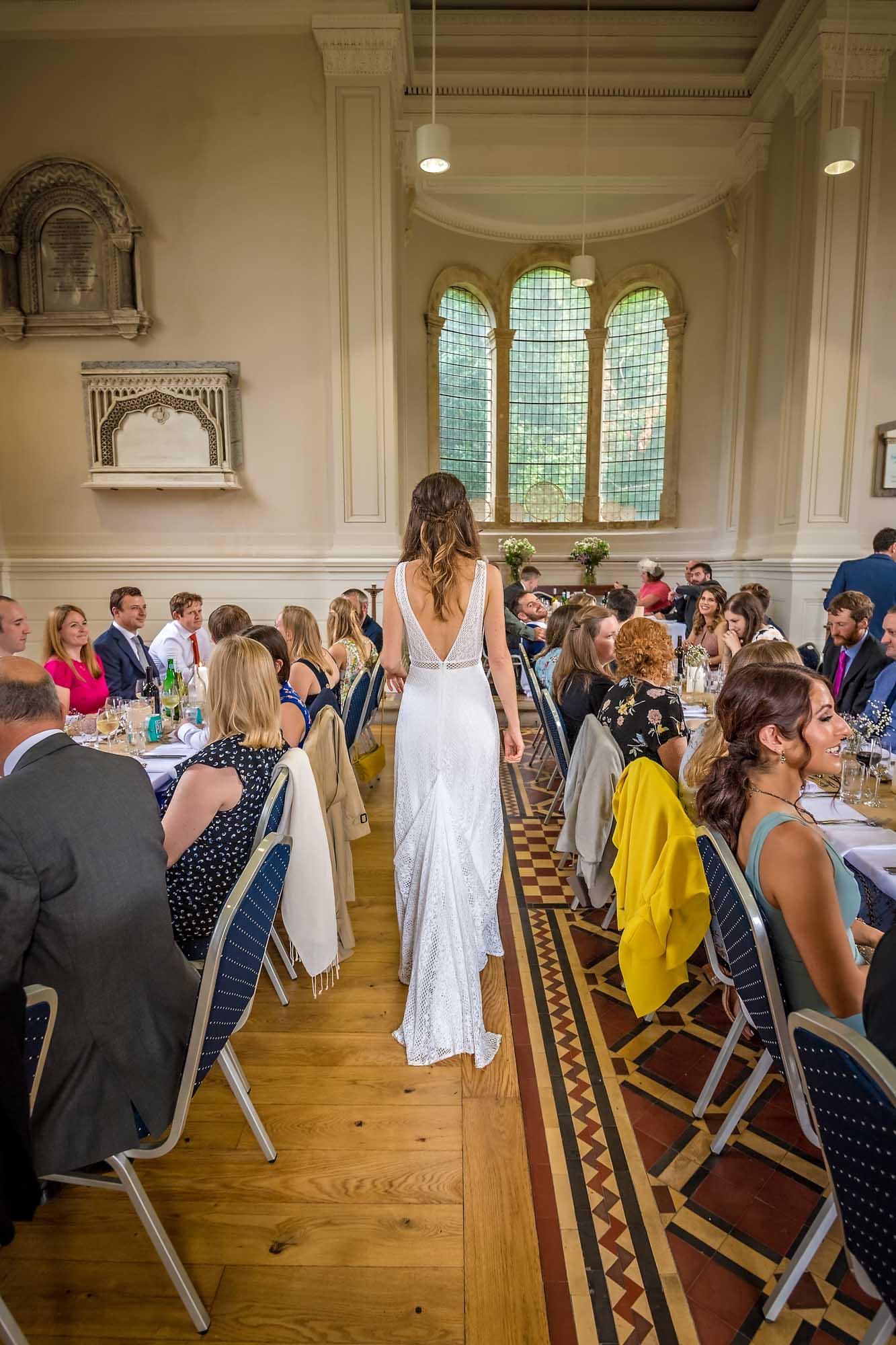 The bride entering the Anglican Chapel at Arnos Vale and walking between tables