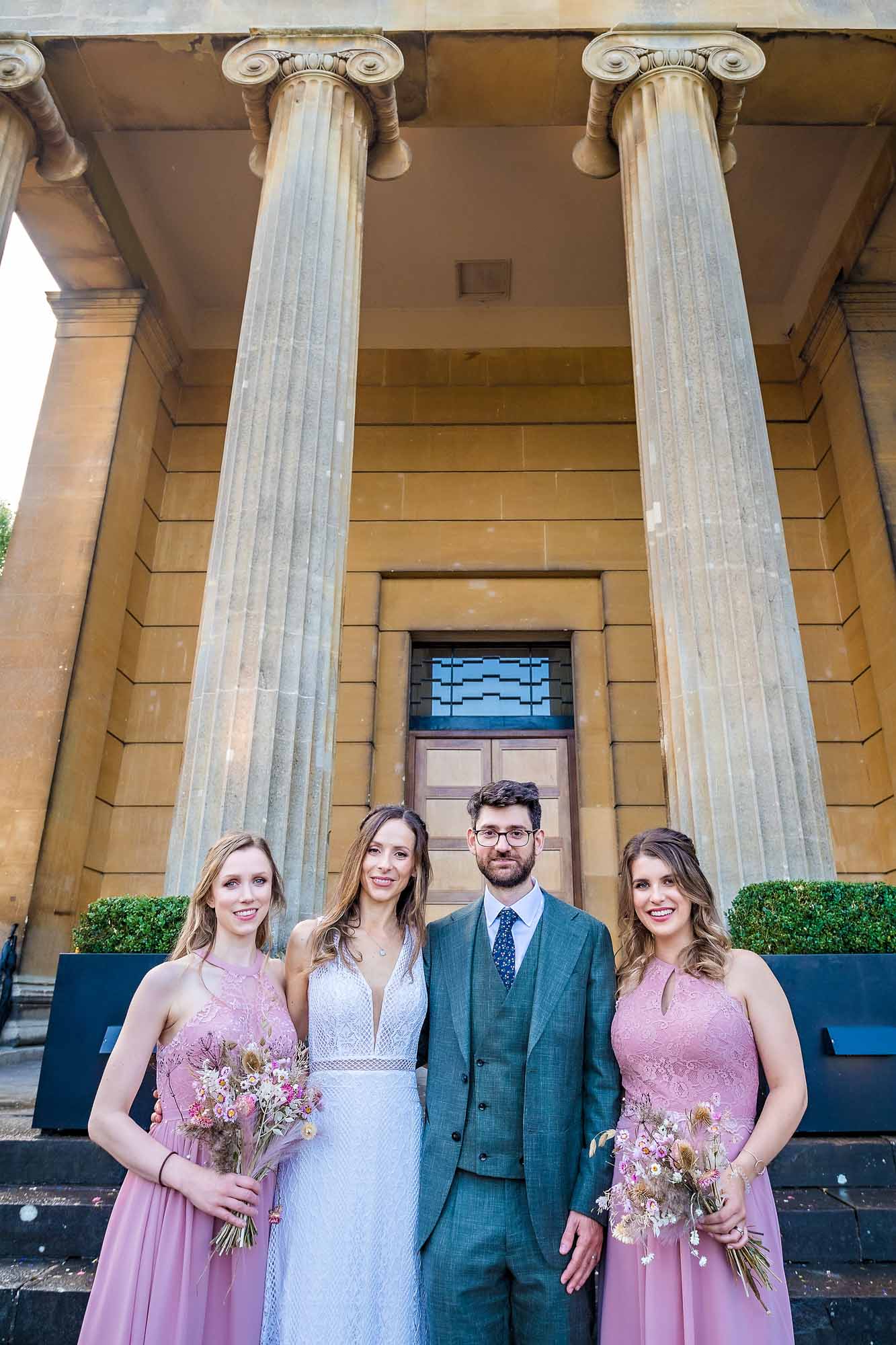 The couple pose with two lilac dressed bridemaids at Arnos Vale